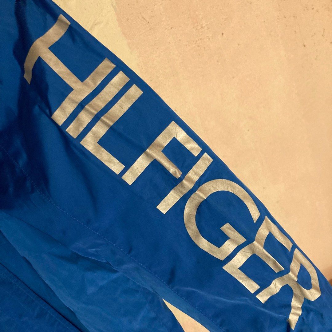 TOMMY HILFIGER BLUE WINDBREAKER JACKET (Category: Coats, Jackets and Outerwear) located in Taguig. Submitted by grindrr (Listing ID 1413425497, Image 2). Description: Hand me down from my grandparents from the US. Perfect for motorcycle rides through cold windy nights. RFS: Never need this. Masyadong vibrant ang color. Issues: Cracked ang mga printed portions of Hilfiger logos Didn't realize na cracked prints on clothes count as "defects". Everyt