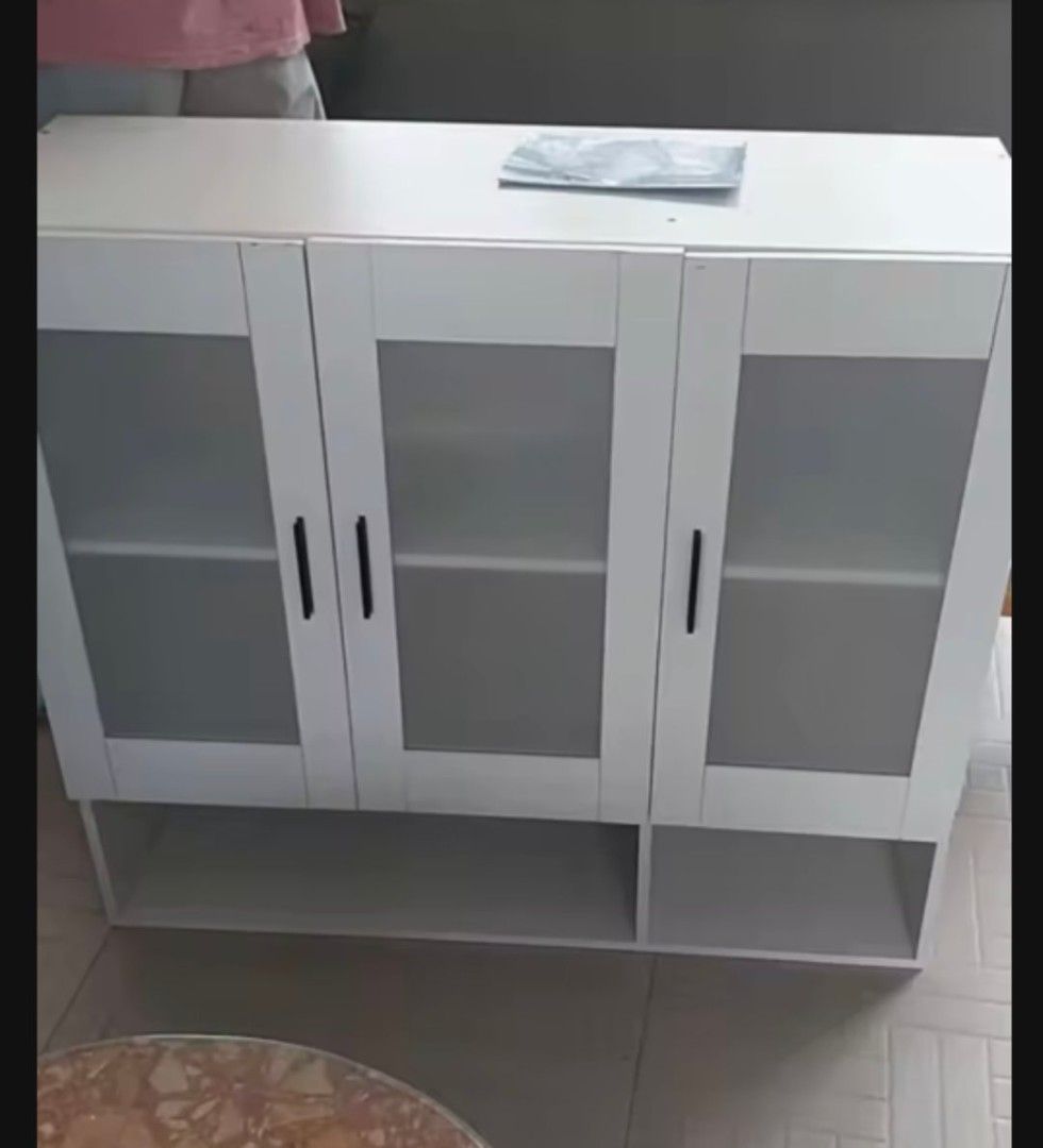 Transparent Wall Cabinet (Category: Shelves, Cabinets & Racks) located in Manila. Submitted by nhi_nin (Listing ID 1413281969, Image 3). Description: - White kitchen wall cabinet - Glass doors - Available sizes: 120x30x80cm and 90x30x80cm - Multiple storage compartments - Includes lower shelf - Perfect for kitchen essentials - Clean, modern design.