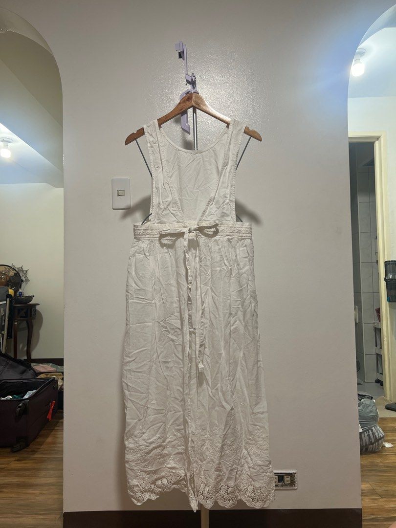 White Apron Dress (Category: Dresses) located in Mandaluyong City. Submitted by faythemaker (Listing ID 1413331450, Image 1). Description: - White apron dress - Tie waist - Lace trim at hem - Lightweight cotton fabric - Suitable for warm weather - Simple, elegant design.