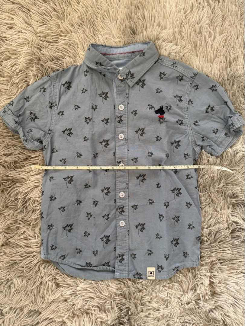 Zach & Mack Polo Shirt (Category: Babies & Kids Fashion) located in Muntinlupa City. Submitted by caistuff (Listing ID 1413242693, Image 3). Description: LAST PRICE POSTED ALREADY. - Zach & Mack short sleeve shirt - Light blue with leaf pattern - Size: XS - Features a small dog logo - Button-down closure - Classic collar - Perfect for casual wear Measurements: - Length: 17 in - Width: 12 in.