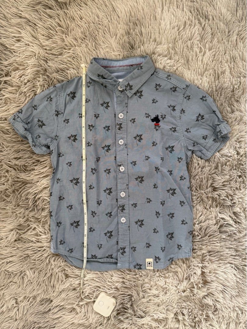 Zach & Mack Polo Shirt (Category: Babies & Kids Fashion) located in Muntinlupa City. Submitted by caistuff (Listing ID 1413242693, Image 2). Description: LAST PRICE POSTED ALREADY. - Zach & Mack short sleeve shirt - Light blue with leaf pattern - Size: XS - Features a small dog logo - Button-down closure - Classic collar - Perfect for casual wear Measurements: - Length: 17 in - Width: 12 in.