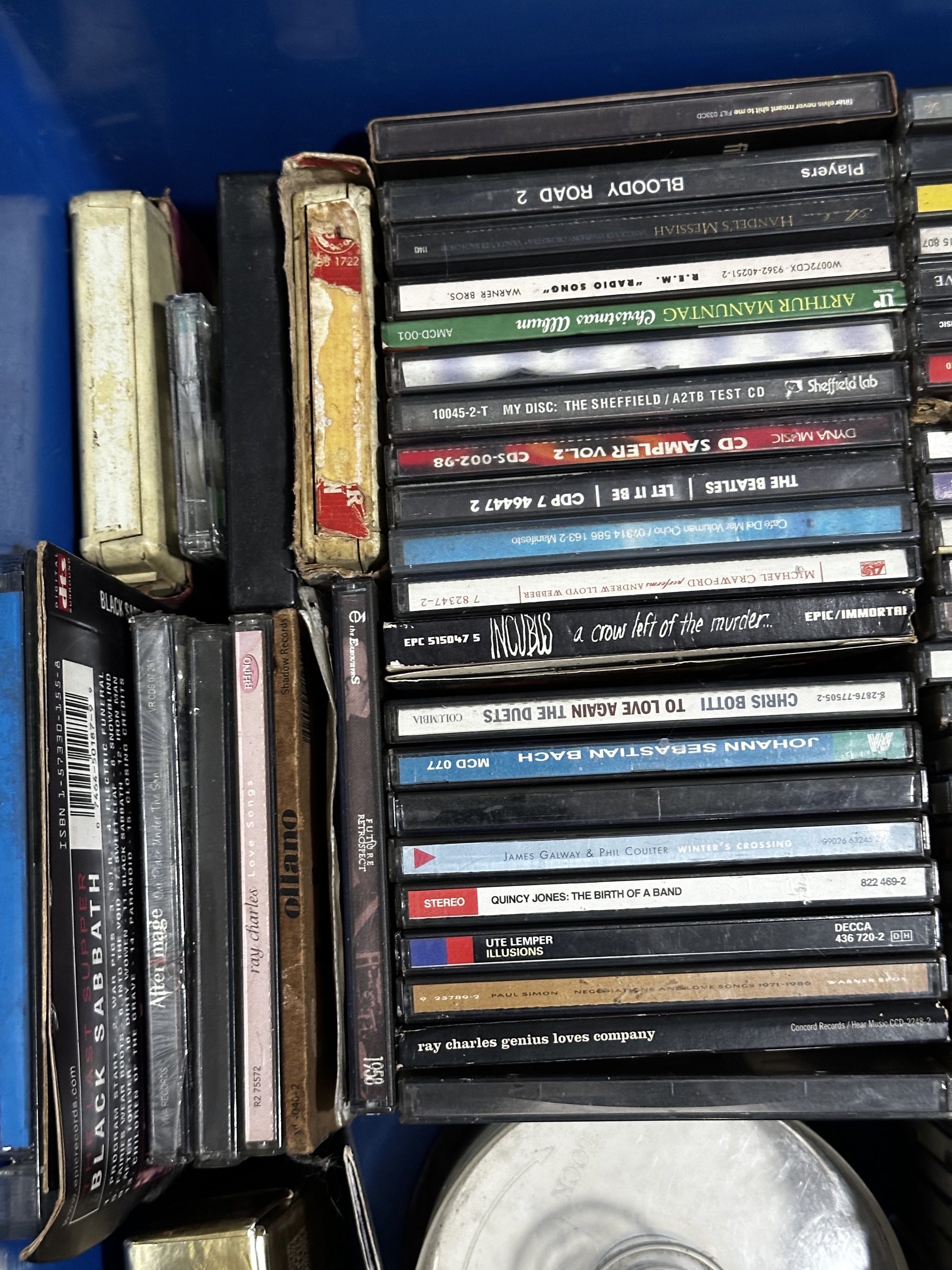 Assorted Music CDs and Cassette Tapes (Category: CDs & DVDs) located in Makati City. Submitted by mjmjmi (Listing ID 1418666997, Image 2). Description: - Music CD and cassette tape collection - Featuring artists like Red Hot Chili Peppers, Barbra Streisand, and Frank Sinatra - Diverse selection of music genres - Some tapes stored in a rack and blue container - Includes various cassette tapes.