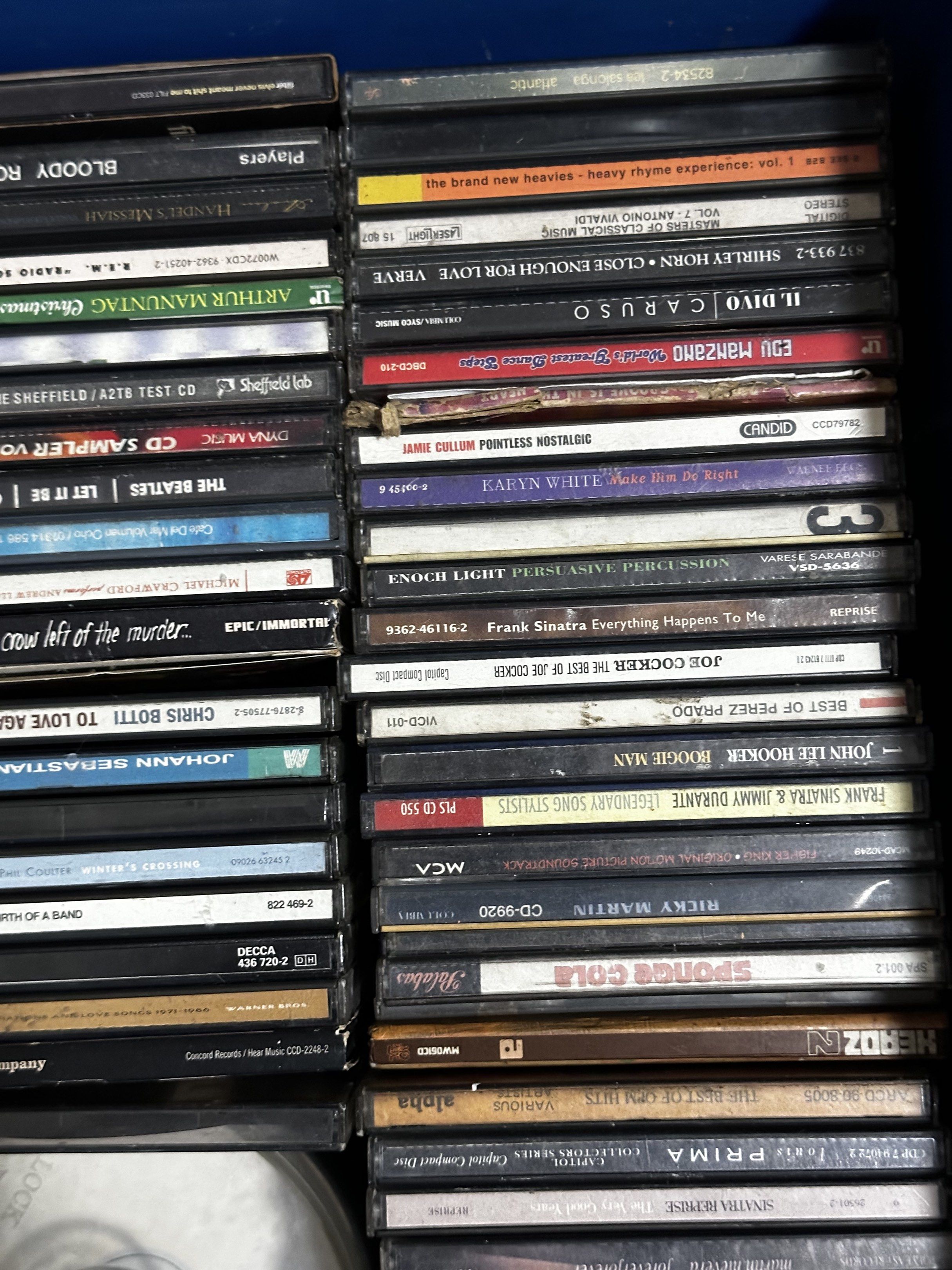 Assorted Music CDs and Cassette Tapes (Category: CDs & DVDs) located in Makati City. Submitted by mjmjmi (Listing ID 1418666997, Image 3). Description: - Music CD and cassette tape collection - Featuring artists like Red Hot Chili Peppers, Barbra Streisand, and Frank Sinatra - Diverse selection of music genres - Some tapes stored in a rack and blue container - Includes various cassette tapes.