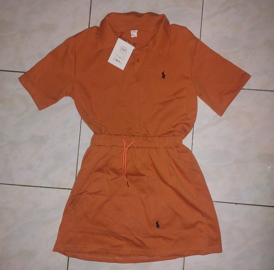 Bangkok Coords/Eunice Polo Dress (Category: Dresses) located in Manila. Submitted by iluvomri (Listing ID 1418702583, Image 1). Description: - Orange polo dress - Drawstring waist - Short sleeves - Collared neckline - Small logo detail - Made of 50% cotton, 50% polyester - Includes Eunice tag.