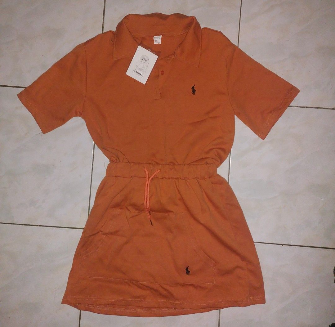 Bangkok Coords/Eunice Polo Dress (Category: Dresses) located in Manila. Submitted by iluvomri (Listing ID 1418702583, Image 2). Description: - Orange polo dress - Drawstring waist - Short sleeves - Collared neckline - Small logo detail - Made of 50% cotton, 50% polyester - Includes Eunice tag.