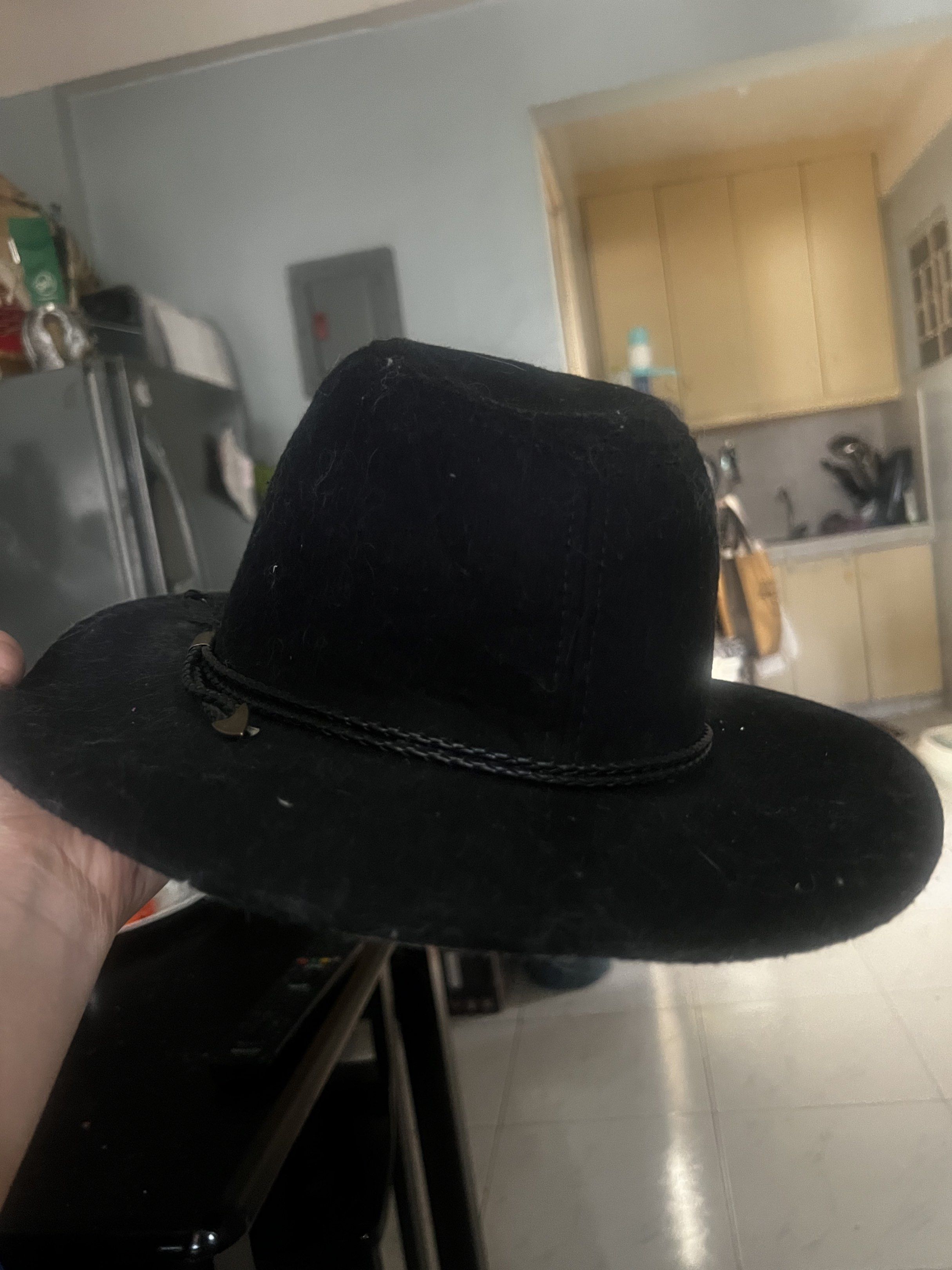 Black Cowboy Hat with Braided Band (Category: Caps & Hats) located in Manila. Submitted by cheek888 (Listing ID 1418776393, Image 2). Description: - Black cowboy hat - Braided band with metal accent - Wide brim - Structured crown - Felt-like material - Classic style.