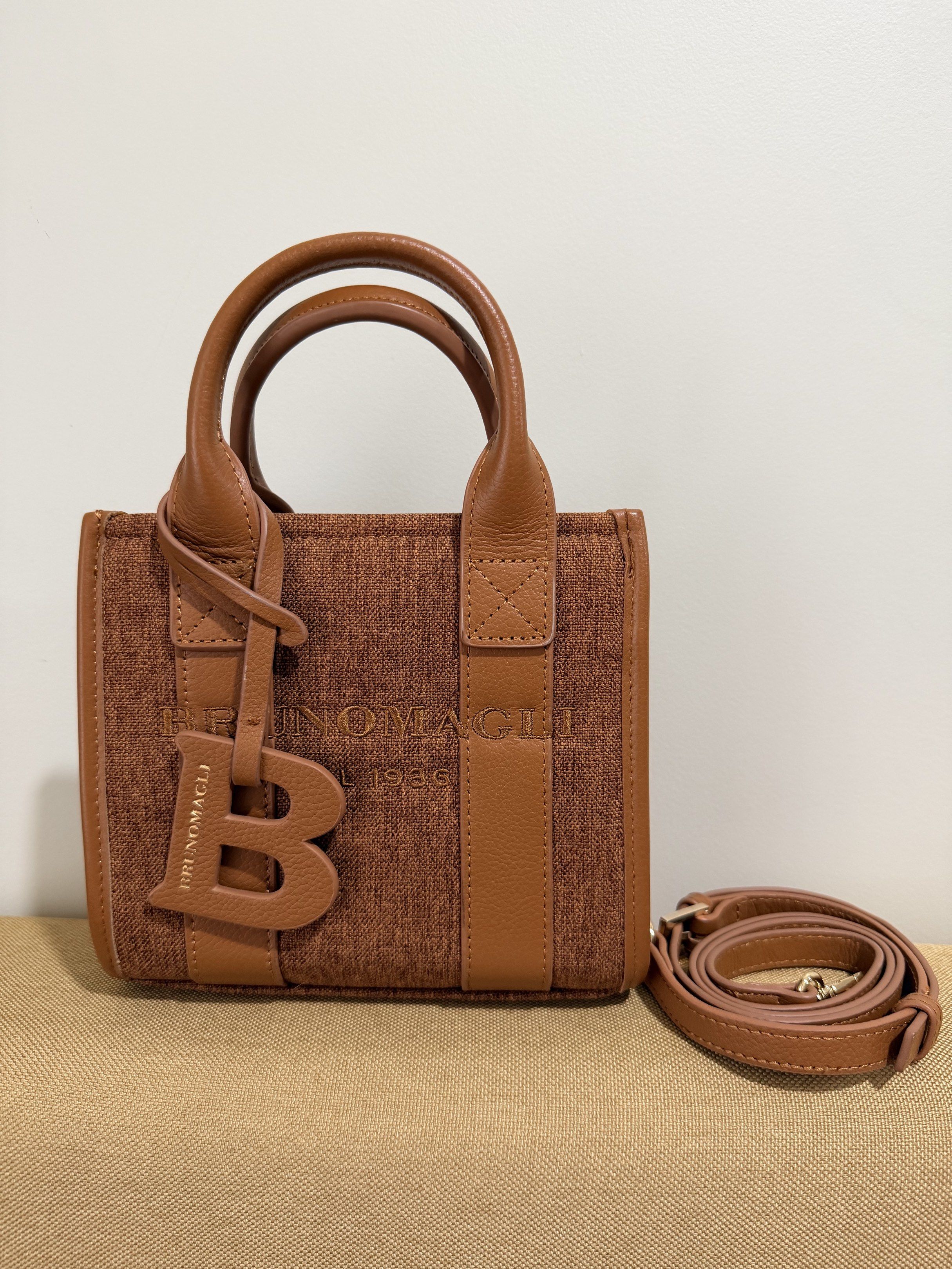 Bruno Magli OTG Small Mini Bag Brown (Category: Tote Bags) located in Quezon City. Submitted by milkybutter21 (Listing ID 1418714090, Image 1). Description: - Brand: Bruno Magli - Color: Brown - Features: - Detachable shoulder strap - Top handle - Magnetic closure - Interior: Pink fabric lining - Details: 'B' charm.