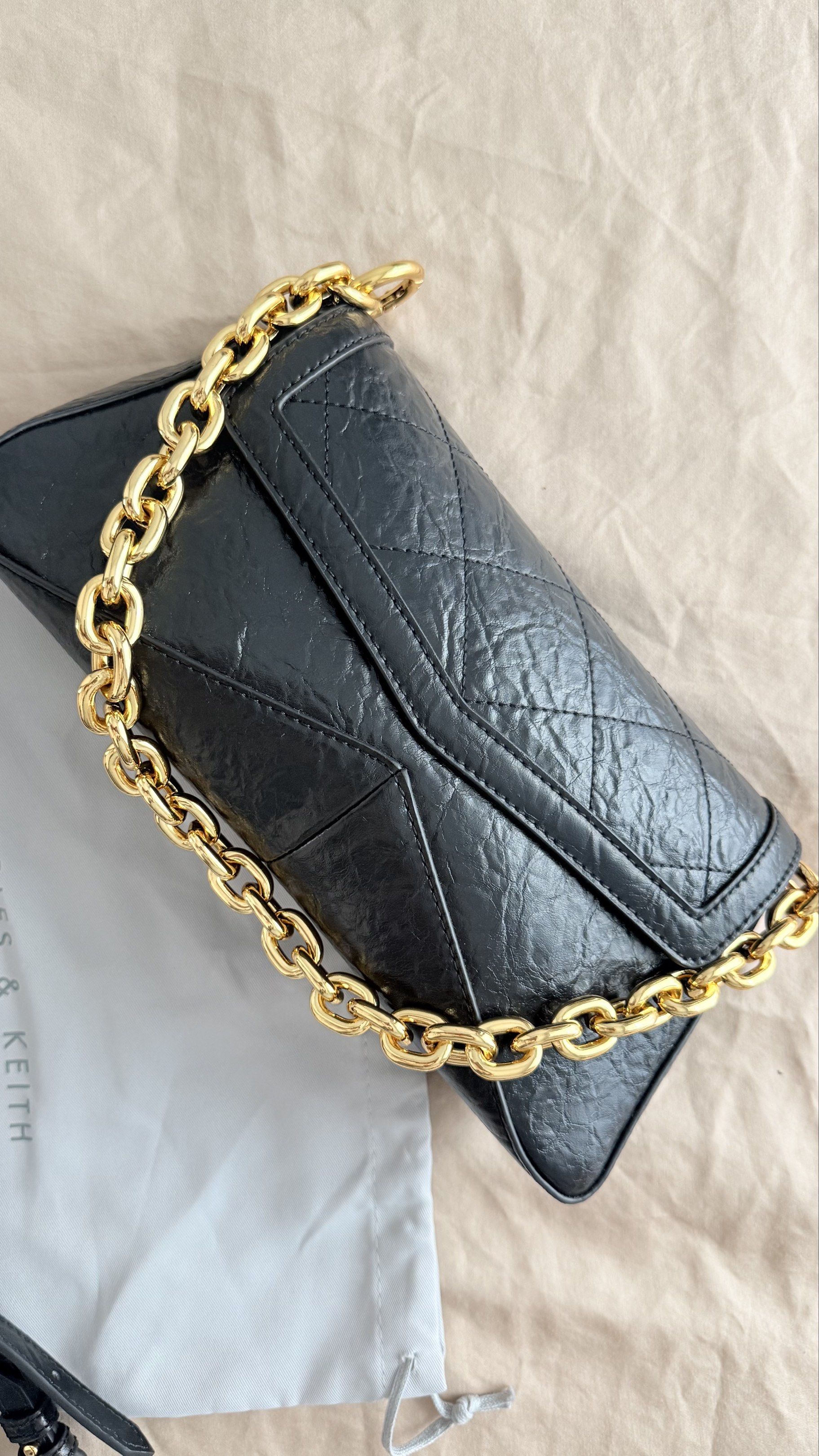 Charles & Keith - Black Shoulder Bag (Category: Shoulder Bags) located in Pasay City. Submitted by jitjitindera (Listing ID 1418602850, Image 3). Description: - Used only twice, bought it at ₱4999. - RFS: decluttering - Color: Black - Detachable gold chain strap - Adjustable strap included - Flap closure - Zippered interior pocket - Includes original dust bag and tags.