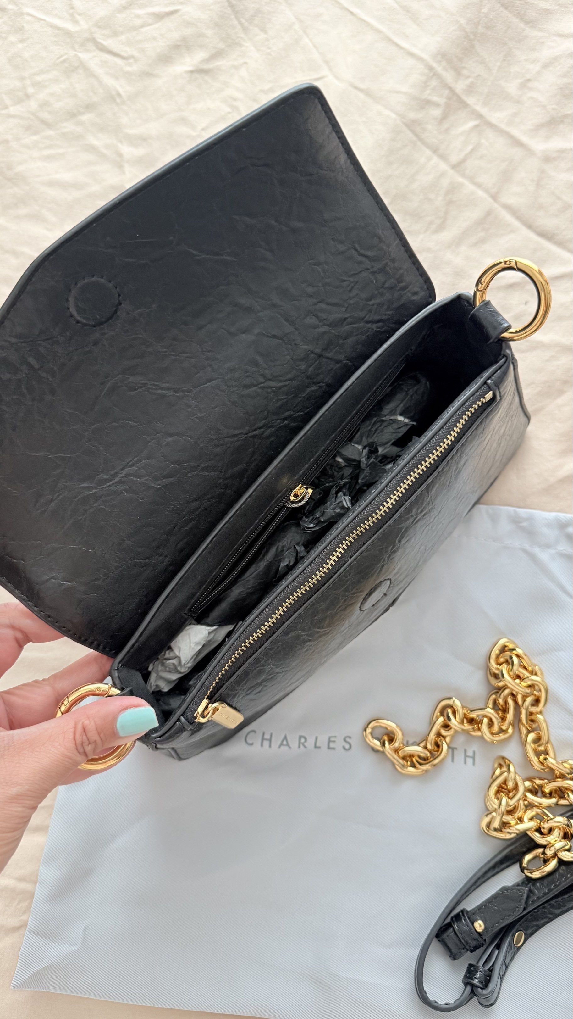 Charles & Keith - Black Shoulder Bag (Category: Shoulder Bags) located in Pasay City. Submitted by jitjitindera (Listing ID 1418602850, Image 2). Description: - Used only twice, bought it at ₱4999. - RFS: decluttering - Color: Black - Detachable gold chain strap - Adjustable strap included - Flap closure - Zippered interior pocket - Includes original dust bag and tags.