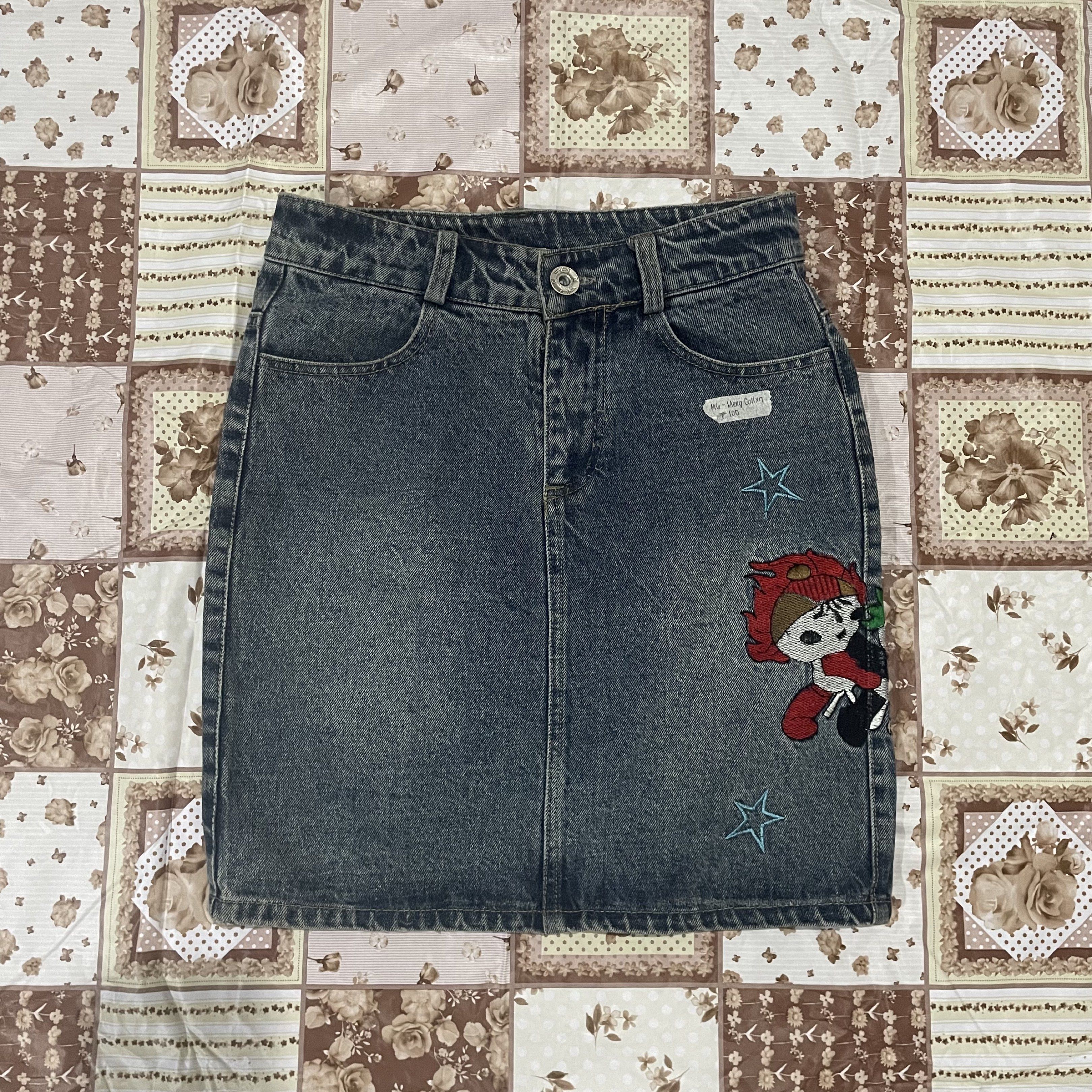 Denim Skirt with Patches (Category: Skirts) located in Caloocan City. Submitted by meng.collxn (Listing ID 1418694864, Image 1). Description: - Denim skirt with a classic wash - Straight cut design - Adorned with star and character patches - Includes two front and two back pockets - Button and zipper closure.
