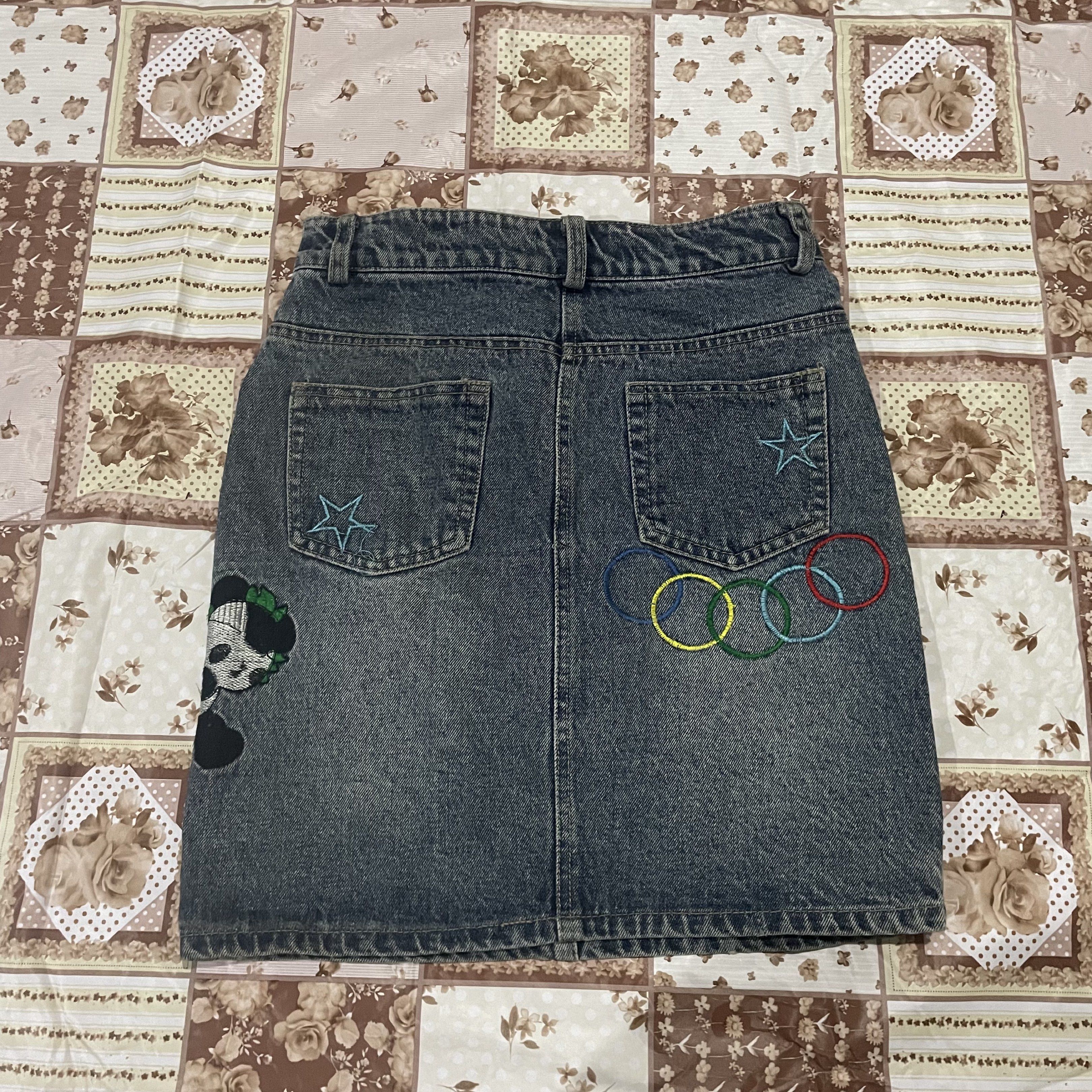 Denim Skirt with Patches (Category: Skirts) located in Caloocan City. Submitted by meng.collxn (Listing ID 1418694864, Image 2). Description: - Denim skirt with a classic wash - Straight cut design - Adorned with star and character patches - Includes two front and two back pockets - Button and zipper closure.