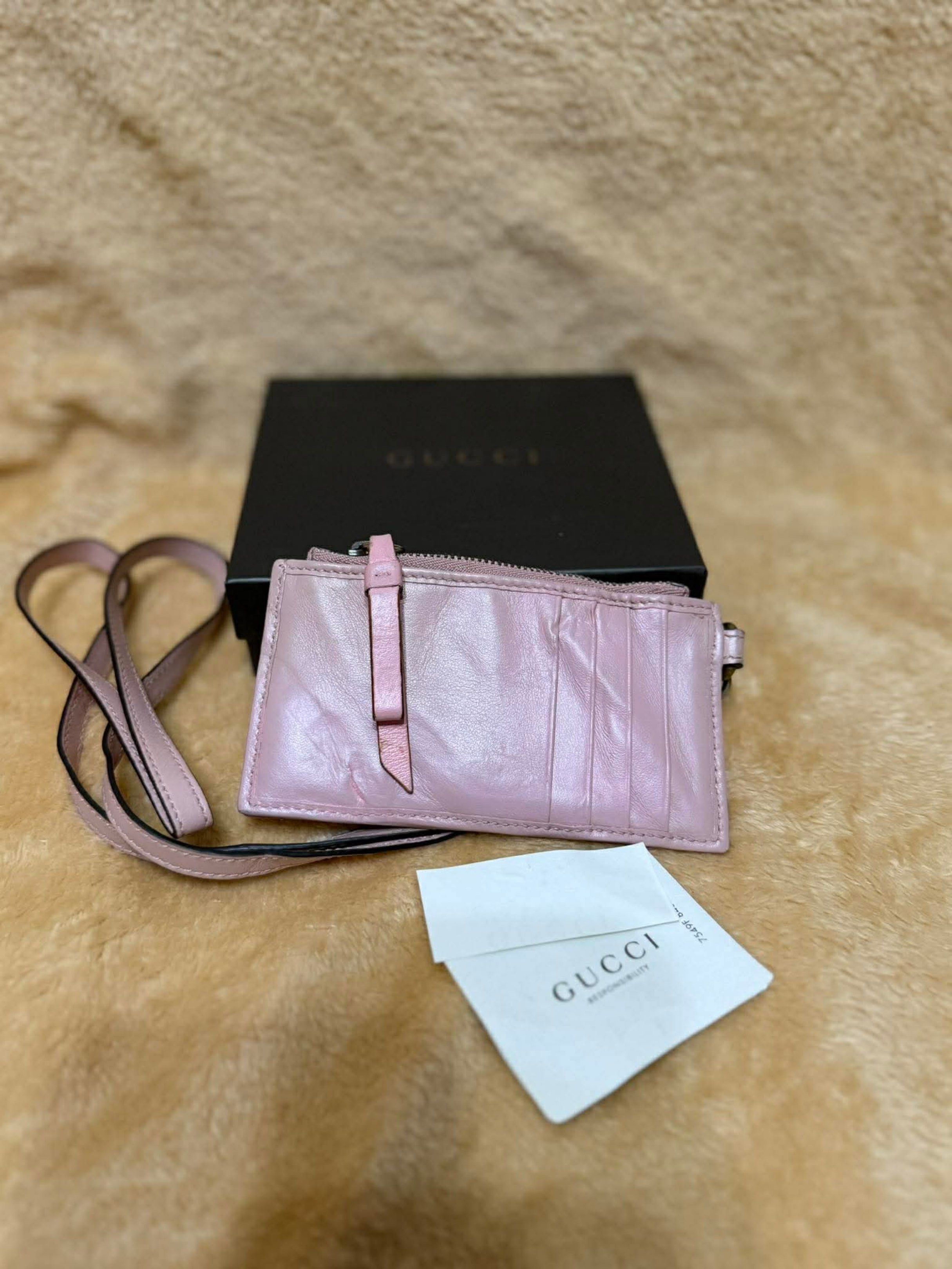Gucci Wallet w/ Lanyard (Category: Luxury Bags & Wallets) located in Manila. Submitted by ceeh.sells (Listing ID 1418732460, Image 2). Description: - Authentic Gucci wallet - Features a pink, quilted design - Iconic GG logo - Includes original box and authenticity card - Zipper closure - Multiple card slots - Comes with a lanyard - Stylish and functional accessory Slight dent/wrinkle due to storage.
