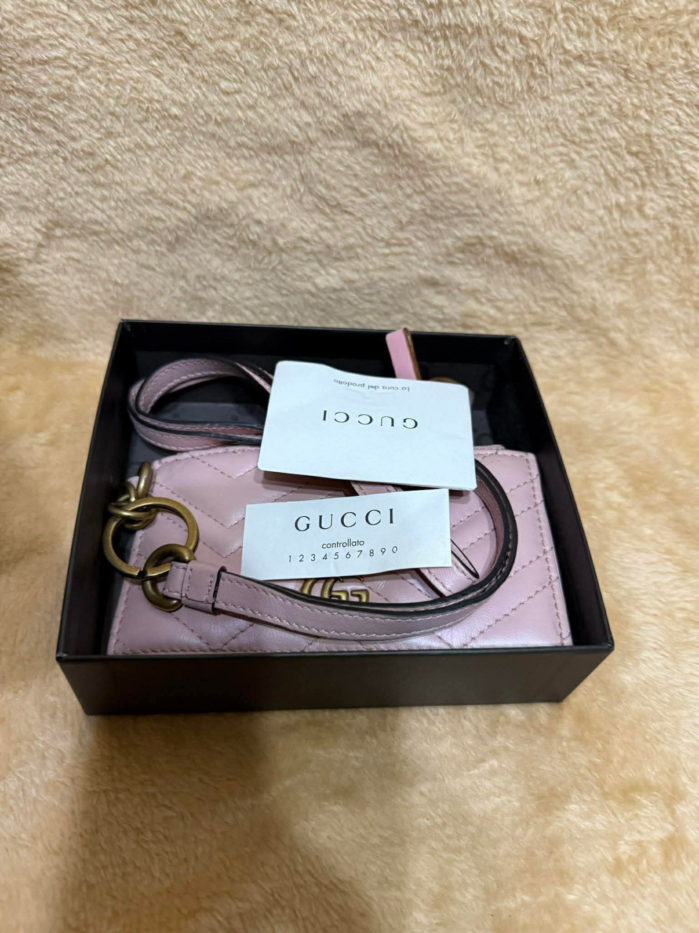 Gucci Wallet w/ Lanyard (Category: Luxury Bags & Wallets) located in Manila. Submitted by ceeh.sells (Listing ID 1418732460, Image 3). Description: - Authentic Gucci wallet - Features a pink, quilted design - Iconic GG logo - Includes original box and authenticity card - Zipper closure - Multiple card slots - Comes with a lanyard - Stylish and functional accessory Slight dent/wrinkle due to storage.