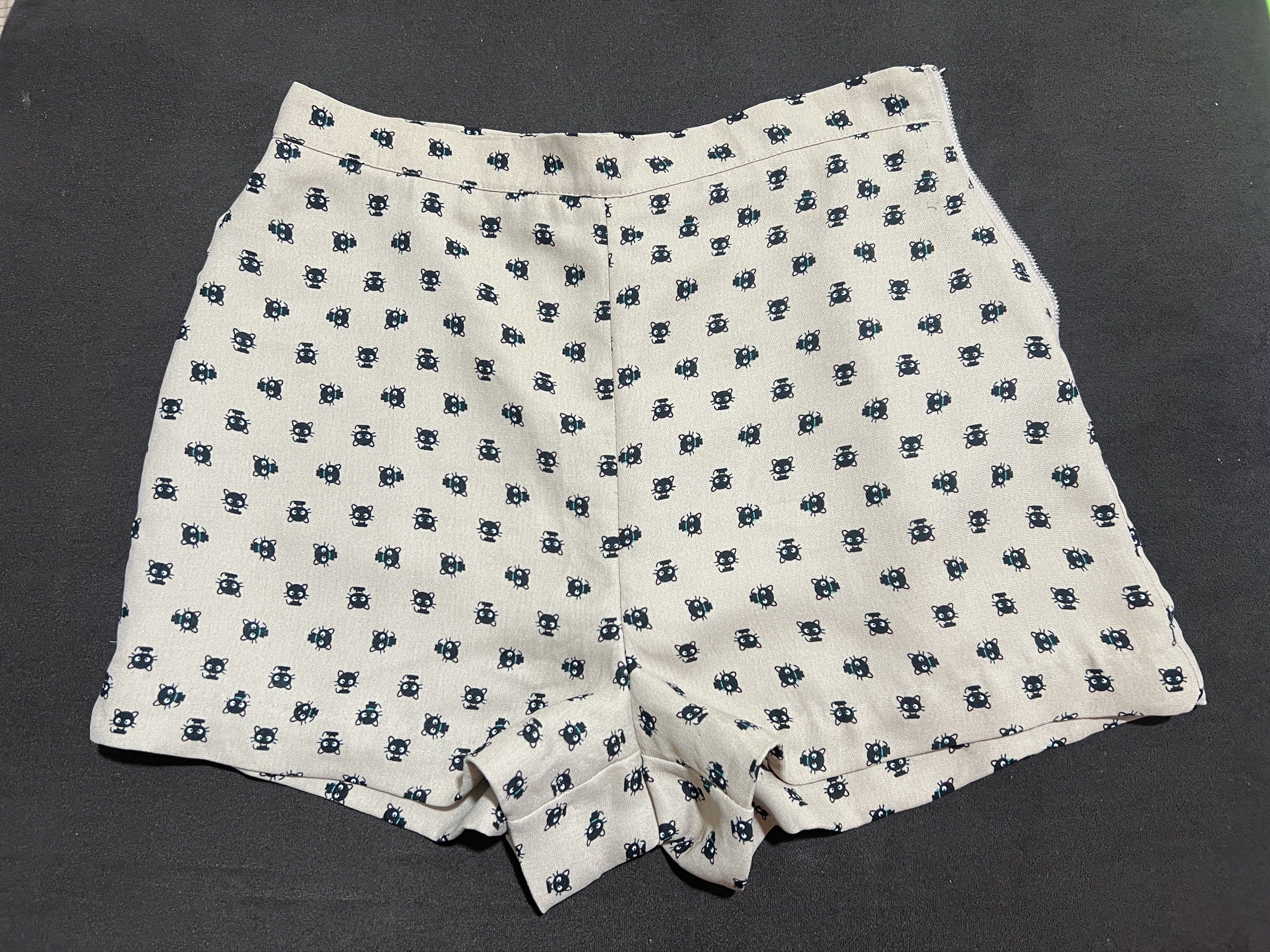 Hello Kitty Forever Shorts - Size M (Category: Shorts) located in Bacoor. Submitted by pktd10 (Listing ID 1418724107, Image 1). Description: - Kitty Forever shorts - Size: M - Features an all-over Kitty print - Color: Beige background with dark blue Kitty pattern - Design: High-waisted.
