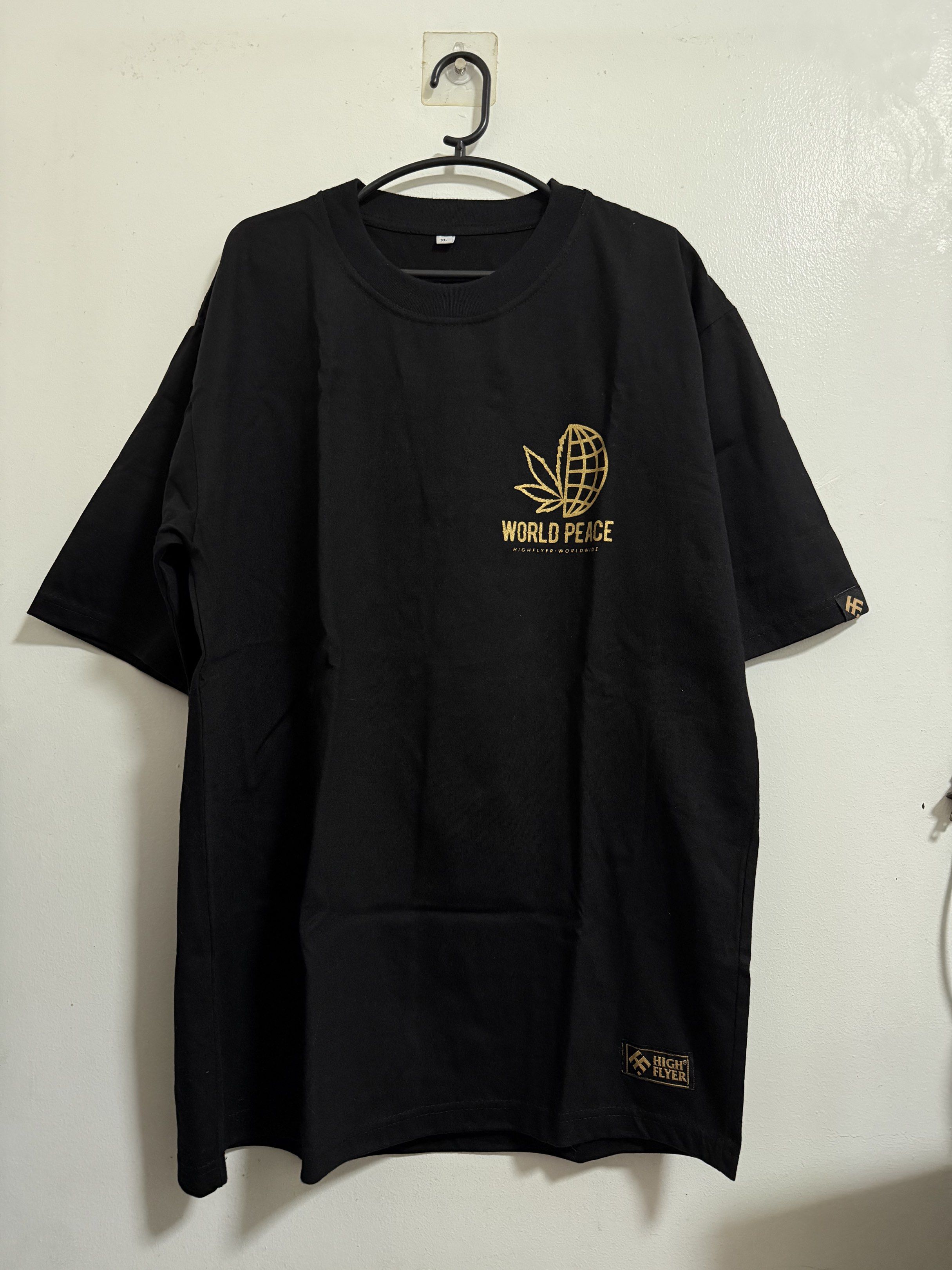High Flyer World Peace T-shirt (Category: Tshirts & Polo Shirts ) located in Bulacan. Submitted by isnvl (Listing ID 1418768524, Image 1). Description: - Black High Flyer T-shirt - Gold "World Peace" design on front and back - XL size - Features cannabis leaf and globe graphic - High Flyer logo on sleeve and bottom.