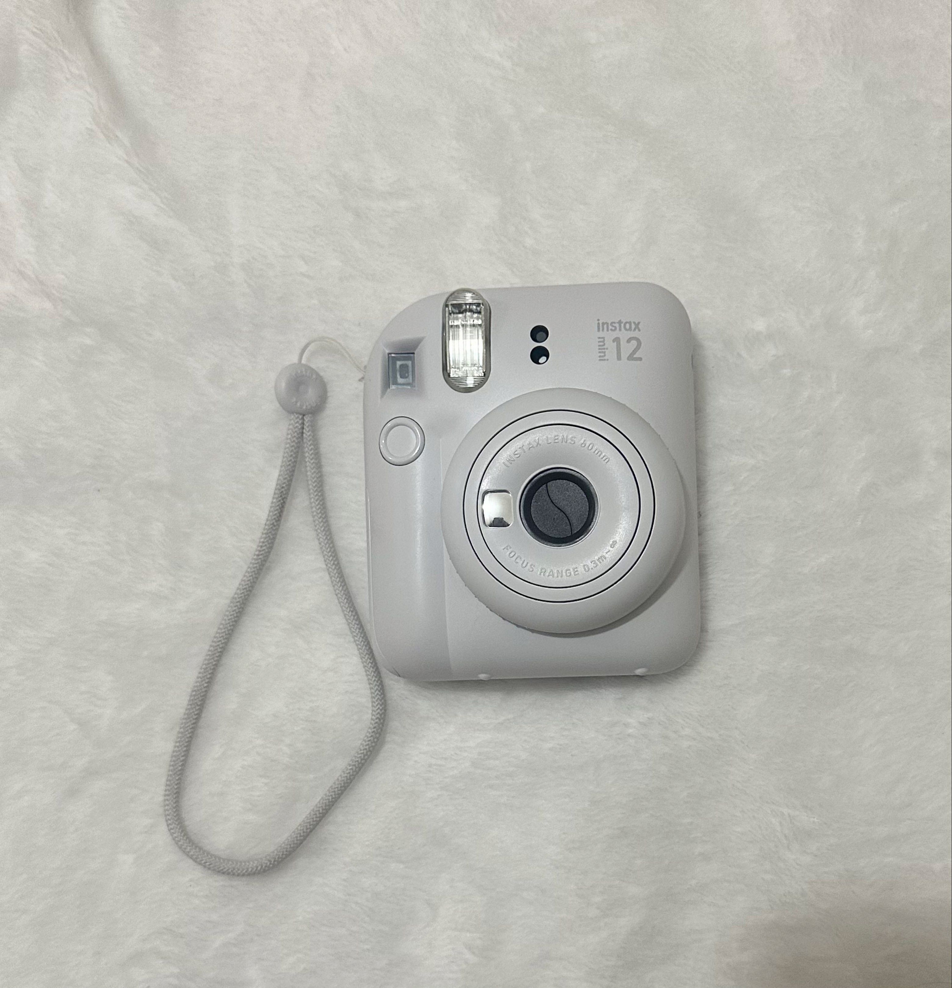 Instax Mini 12 Camera Bundle (Category: Cameras) located in Pasig City. Submitted by prelovedoftang (Listing ID 1418711048, Image 2). Description: - Instax Mini 12 Camera (Light Gray) - Beige Quilted Crossbody Bag - Beige Photo Frame with Clear Window - Keychain with Clear Holder.