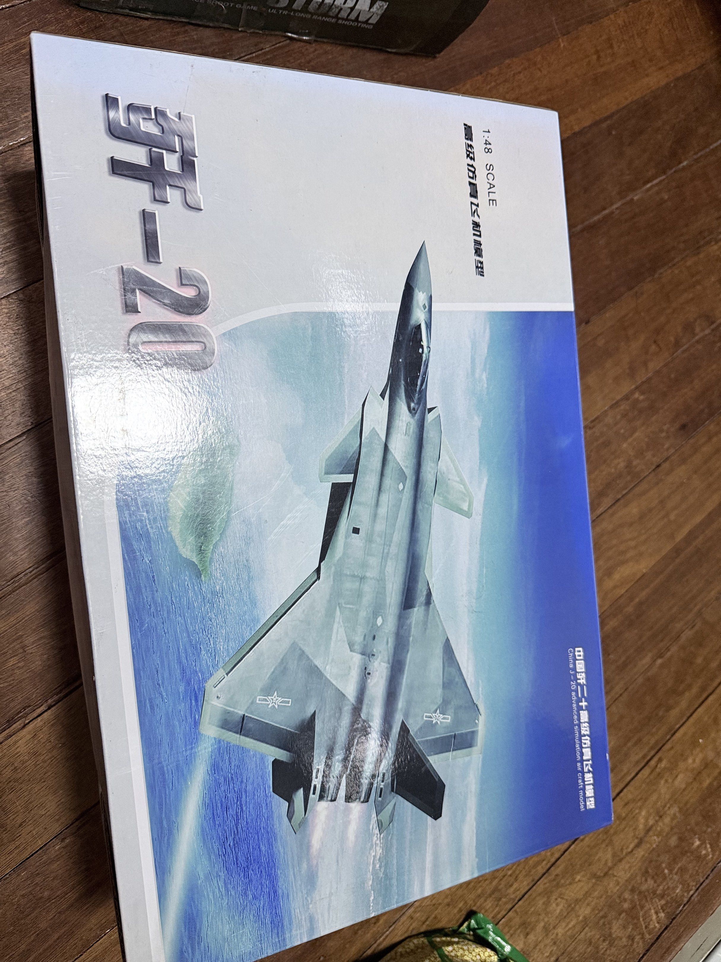 J-20 Fighter Jet 1:48 Scale Model (Category: Vehicle & Diecast Models) located in Mandaluyong City. Submitted by shoppingbag_mom (Listing ID 1418607385, Image 3). Description: - 1:48 scale model of the J-20 fighter jet. - Silver color. - Comes in its original box. - Box features images and Chinese text. - Model is new, still in original packaging. - Protected by styrofoam. - Box indicates it's a simulation aircraft model..