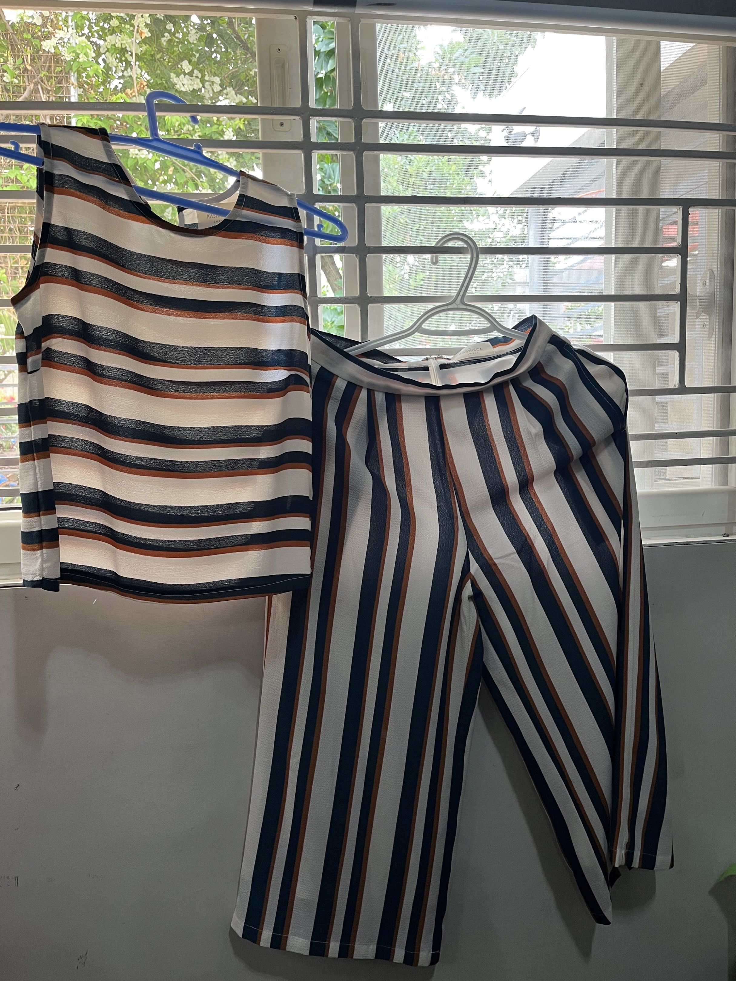 KASHIECA Striped Top and Pants Set - Small (Category: Sets or Coordinates) located in Las Pinas. Submitted by sortandsimplify (Listing ID 1418773037, Image 1). Description: - KASHIECA two-piece set - Includes a sleeveless top and pants - Features a striped pattern (white, navy, brown) - Top: Round neckline - Pants: Wide-legged - Size: Small.