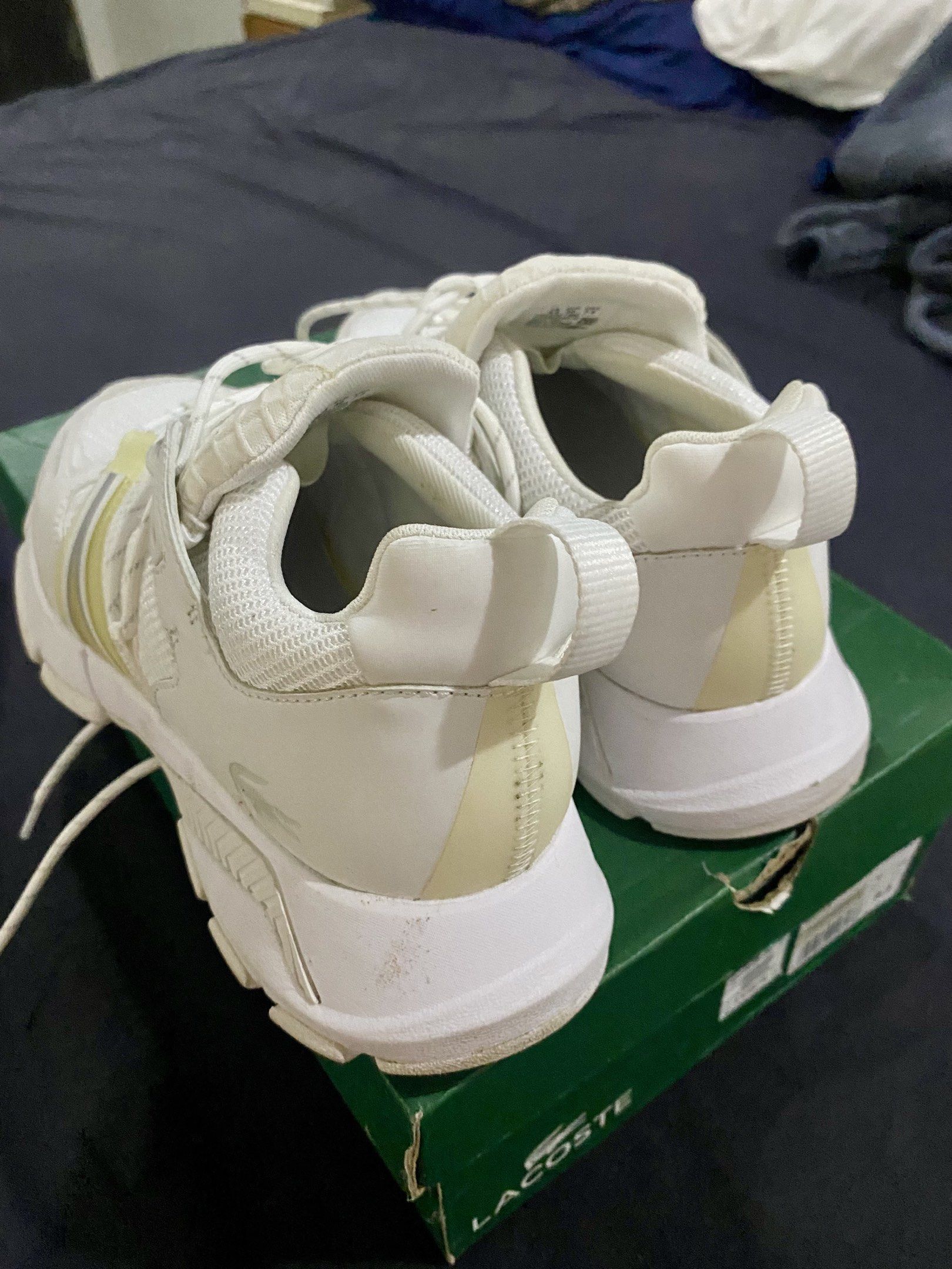 Lacoste SMA White Sneakers (Category: Sneakers) located in Pasig City. Submitted by iphel (Listing ID 1418637890, Image 3). Description: - Lacoste SMA sneakers - White with light yellow accents - Size: 6.5 UK / 40 EUR / 7.5 USA - Textile material - Includes original box - Made in Vietnam Used 2x. Perfect fift for Size 39 with wide feet..