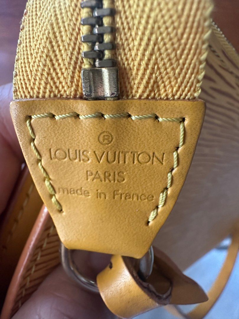 Louis Vuitton Epi Pochette Accessories Clutch (Category: Luxury Bags & Wallets) located in Naga. Submitted by jenni2003 (Listing ID 1418599250, Image 3). Description: - Authentic Louis Vuitton Epi Pochette Accessories Clutch - Stunning yellow color - Zip closure - Detachable strap - Gold-tone hardware - Purple fabric lining - Made in France - Serial number: AR0969 - Iconic Epi leather with LV logo *no inclusion*.