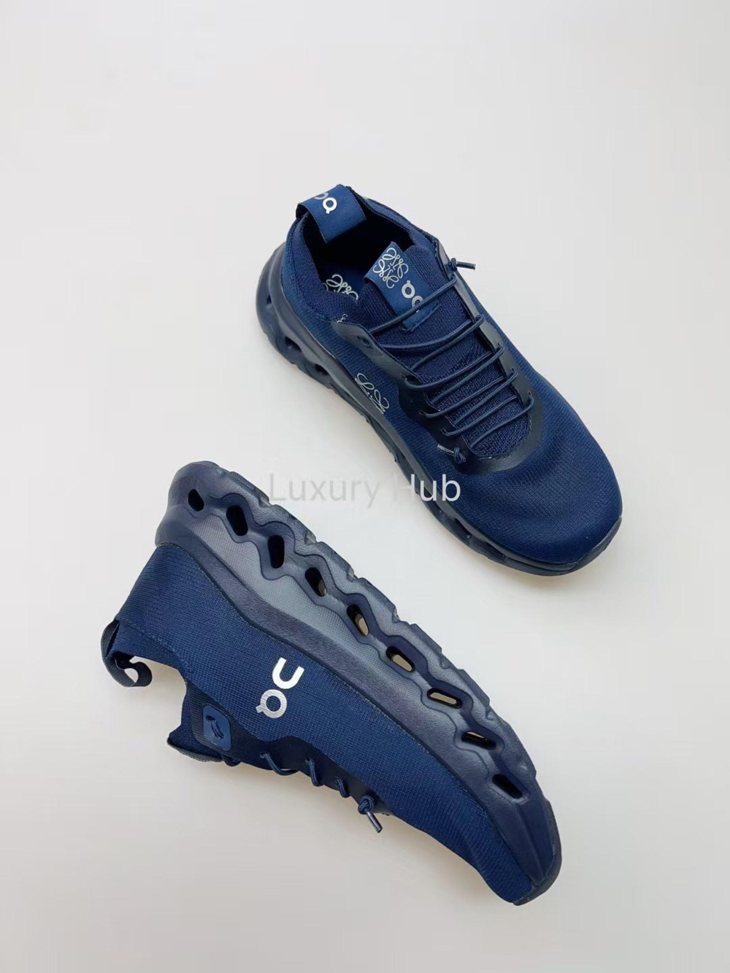 On Cloud x Loewe Navy Sneakers (Category: Sneakers) located in Del Monte. Submitted by smxtapbana46660 (Listing ID 1418613551, Image 3). Description: - Loewe x On Cloud collaboration sneakers - Navy color - Unique design - Breathable upper - Distinctive sole - Includes extra navy laces - Loewe logo on tongue and laces - On Cloud logo on side -used once -with box - authentic - rfs : bought another one.