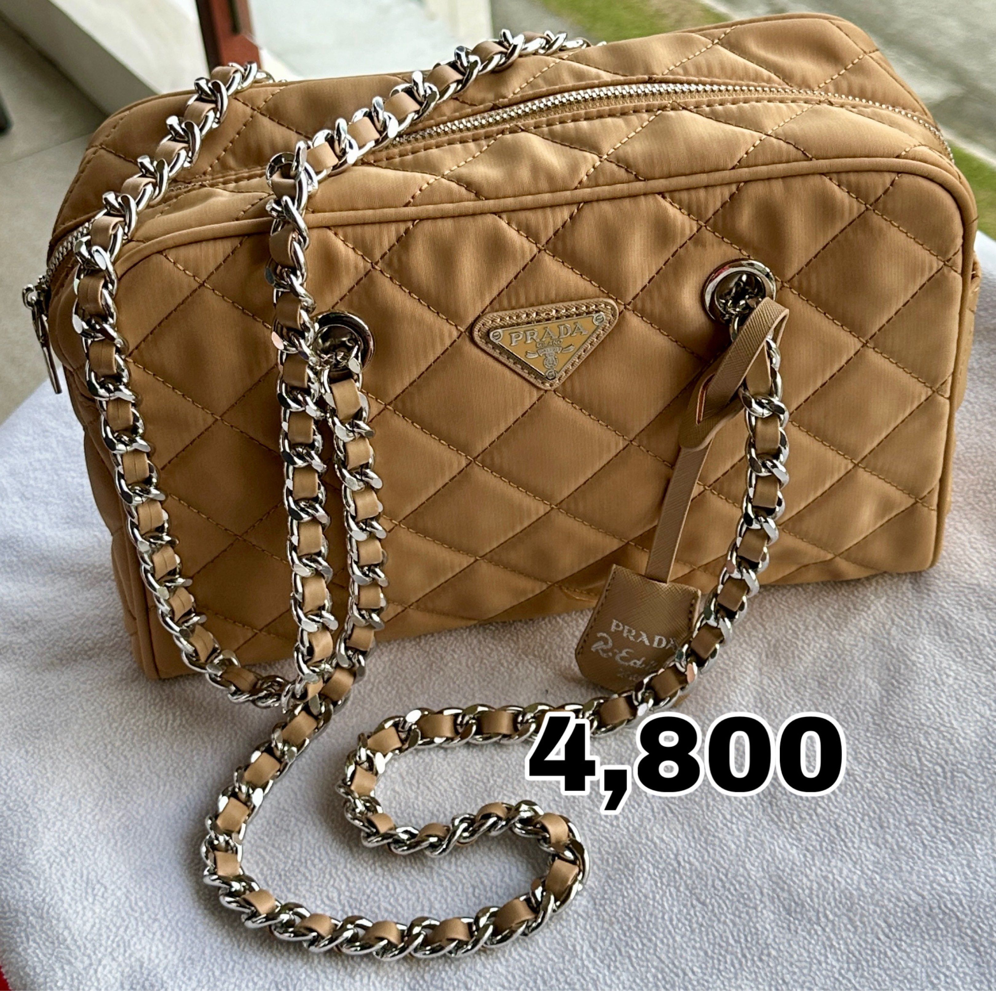 Prada Re-Edition Quilted Chain Bag (Category: Luxury Bags & Wallets) located in Manila. Submitted by andreaaarut (Listing ID 1418652954, Image 1). Description: - Prada Re-Edition Bag - Quilted design - Elegant chain strap - Classic rectangular shape - Features the iconic Prada logo - Beautiful tan color - Price: PHP 4,800.
