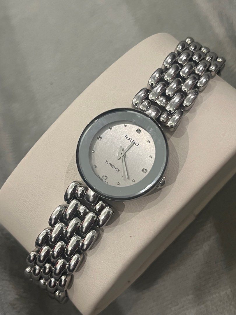 Rado Florence Swiss Made Watch (Category: Luxury Watches) located in Quezon City. Submitted by omymhmatthew (Listing ID 1418769855, Image 2). Description: Rado Florence Swiss Made watch with a silver dial and stainless steel bracelet. The watch features a sapphire crystal and is water-sealed. The clasp is marked with "Stainless Steel" and the model number is 318.5744.4. The serial number is 12531371. The watch has a unique bracelet design. Brand: