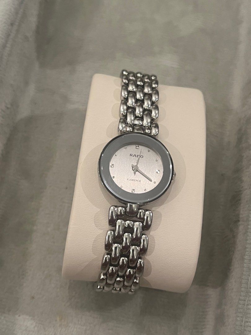 Rado Florence Swiss Made Watch (Category: Luxury Watches) located in Quezon City. Submitted by omymhmatthew (Listing ID 1418769855, Image 1). Description: Rado Florence Swiss Made watch with a silver dial and stainless steel bracelet. The watch features a sapphire crystal and is water-sealed. The clasp is marked with "Stainless Steel" and the model number is 318.5744.4. The serial number is 12531371. The watch has a unique bracelet design. Brand: