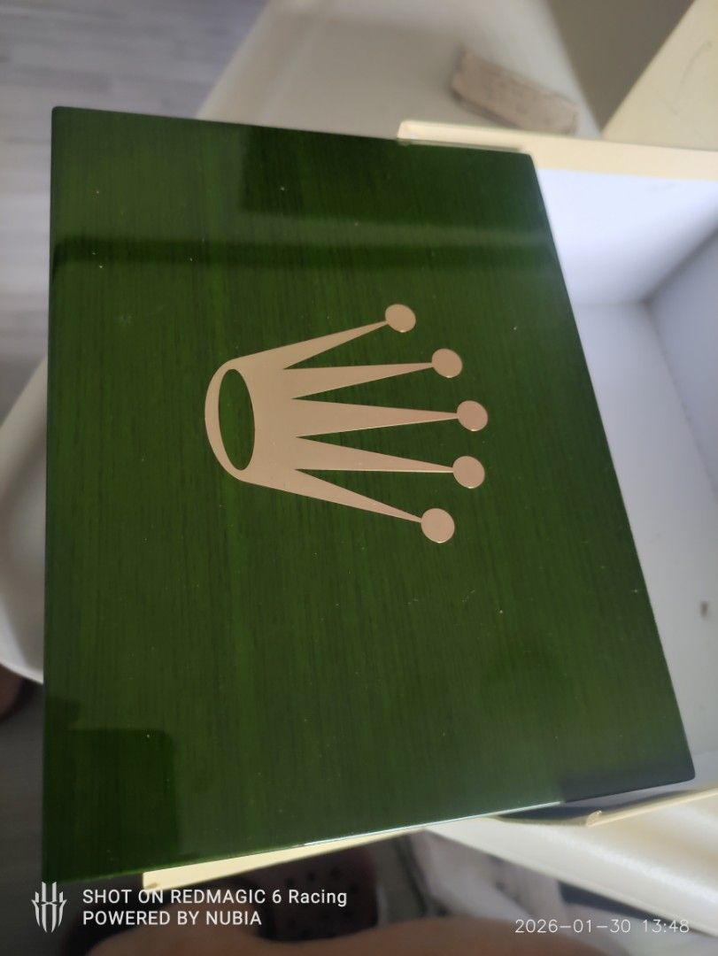 Rolex large Watch Box (Category: Luxury Watches) located in Manila. Submitted by alfredaguirre0819 (Listing ID 1418646336, Image 1). Description: large Rolex watch box. Includes the outer box, inner presentation box, and card holder. The inner box is green with the Rolex crown logo. The interior is beige with a compartment for the watch and card. The outer box is white with the Rolex logo. location paranaque Mandaluyong or Taguig gb ty for visiti