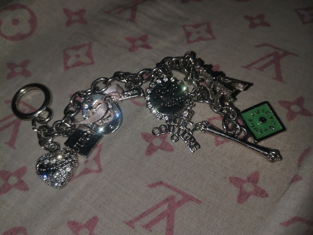 Silver Juicy Couture Bracelet (Category: Charms) located in Manila. Submitted by krishneveragain (Listing ID 1418706238, Image 2). Description: - Silver keychain - Features heart, horseshoe, and green square charms - Includes a key ring - Charms connected by a chain - Made of metal.