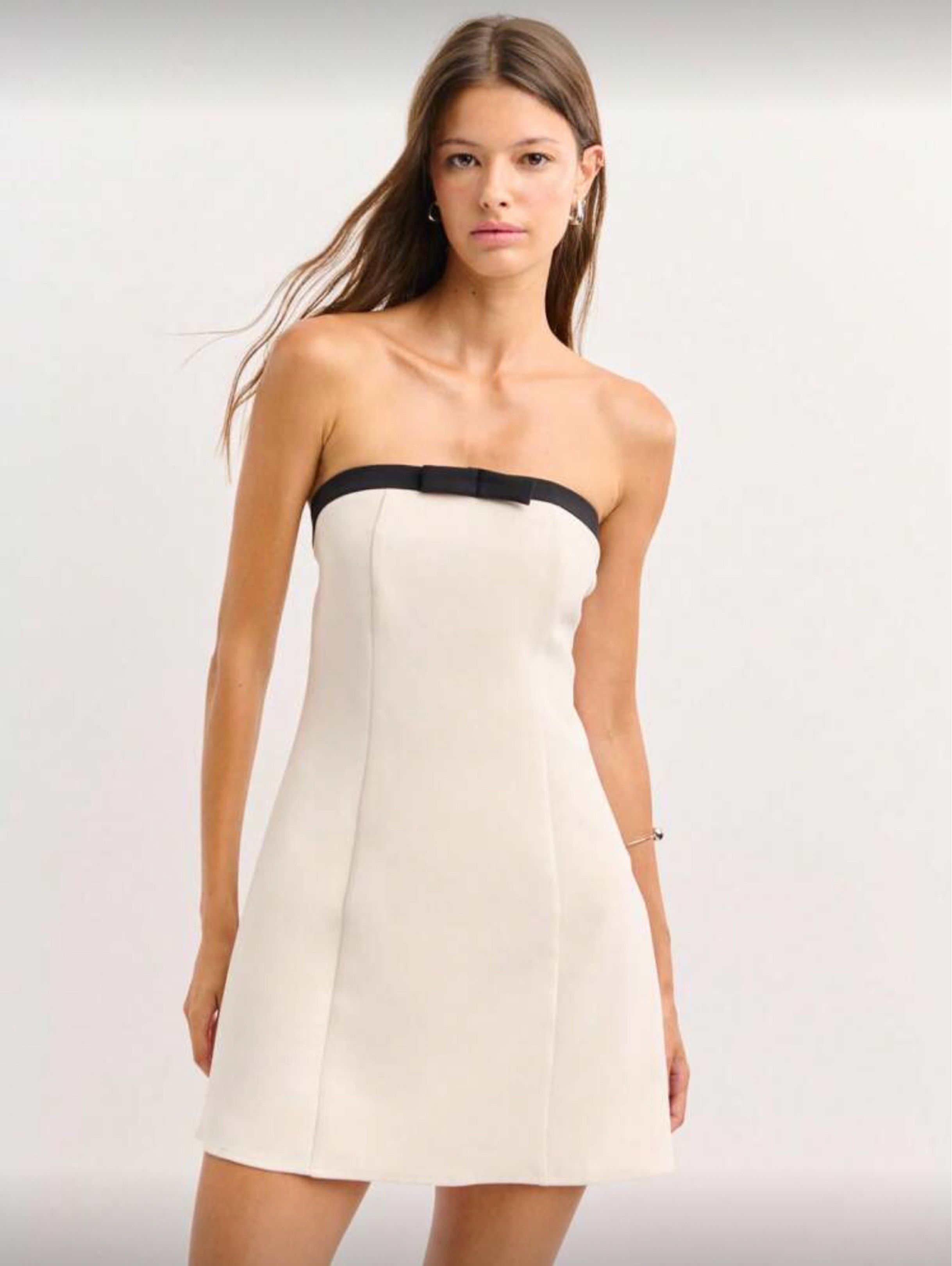 Strapless Beige Mini Dress with Bow Detail (Category: Dresses) located in Cebu City. Submitted by chocogab (Listing ID 1418713545, Image 1). Description: - Strapless mini dress - Contrasting black trim and bow detail - Flattering A-line silhouette - Unique back design with black straps and bows - Perfect for special occasions and nights out tried on and used for a corpo shoot only .