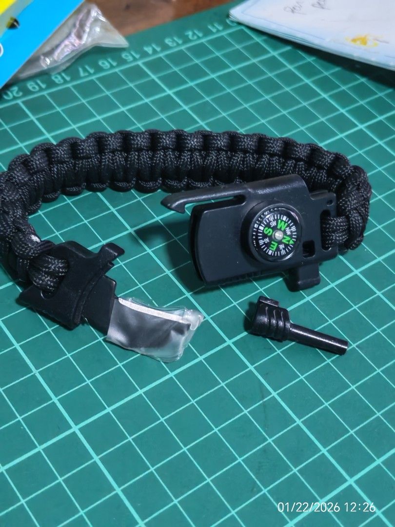 Survival Bracelet with Compass and Fire Starter (Category: Bracelets) located in Manila. Submitted by GentleGiant (Listing ID 1418674821, Image 2). Description: - Black paracord survival bracelet - Built-in compass - Includes a fire starter - Features a knife - Ideal for outdoor activities and emergencies - Compact and versatile survival tool.