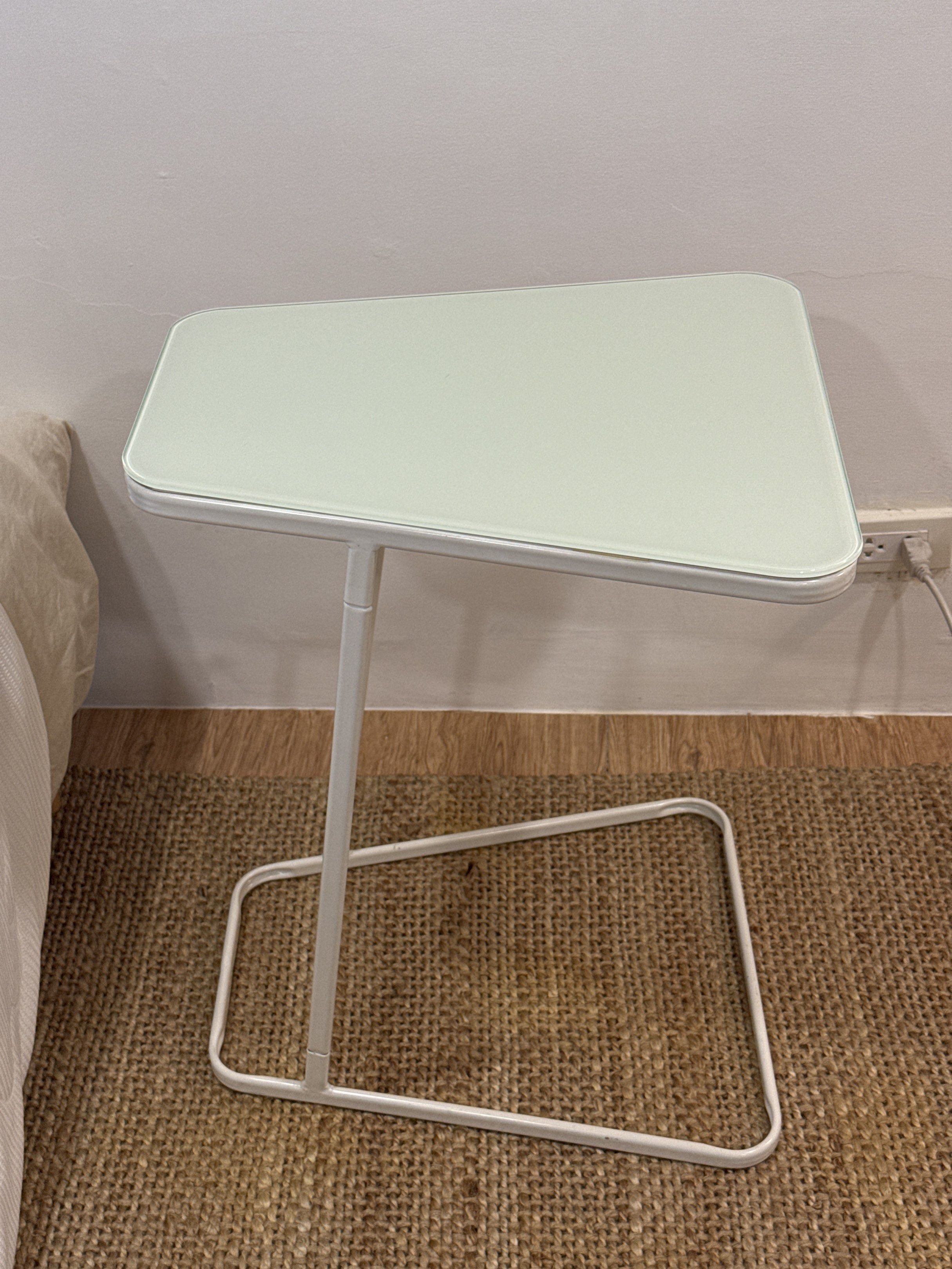 White Side Table with Glass Top (Category: Tables & Sets) located in Marikina City. Submitted by kbarellano (Listing ID 1418681235, Image 2). Description: – Selling 2 units, ₱1,500 each - Originally bought for ₱2,500 from Furniture Source - Tempered painted glass – Curved edge table – Epoxy coating leg Width: 52 cm Depth: 44 cm Height: 62 cm.