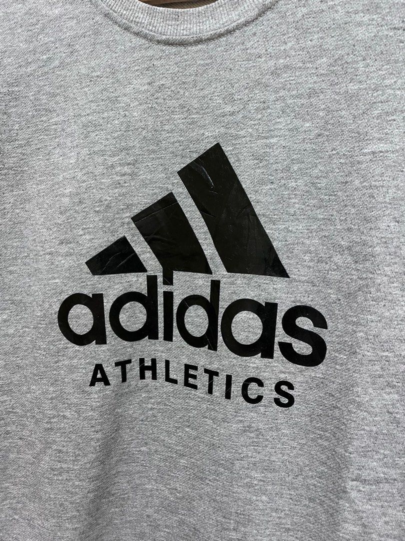 Adidas Athletics Sweatshirt (Category: Coats, Jackets and Outerwear) located in Surigao. Submitted by vbimo (Listing ID 1418886940, Image 2). Description: - Adidas Athletics sweatshirt - Color: Gray - Size: Medium - Adidas logo on front.