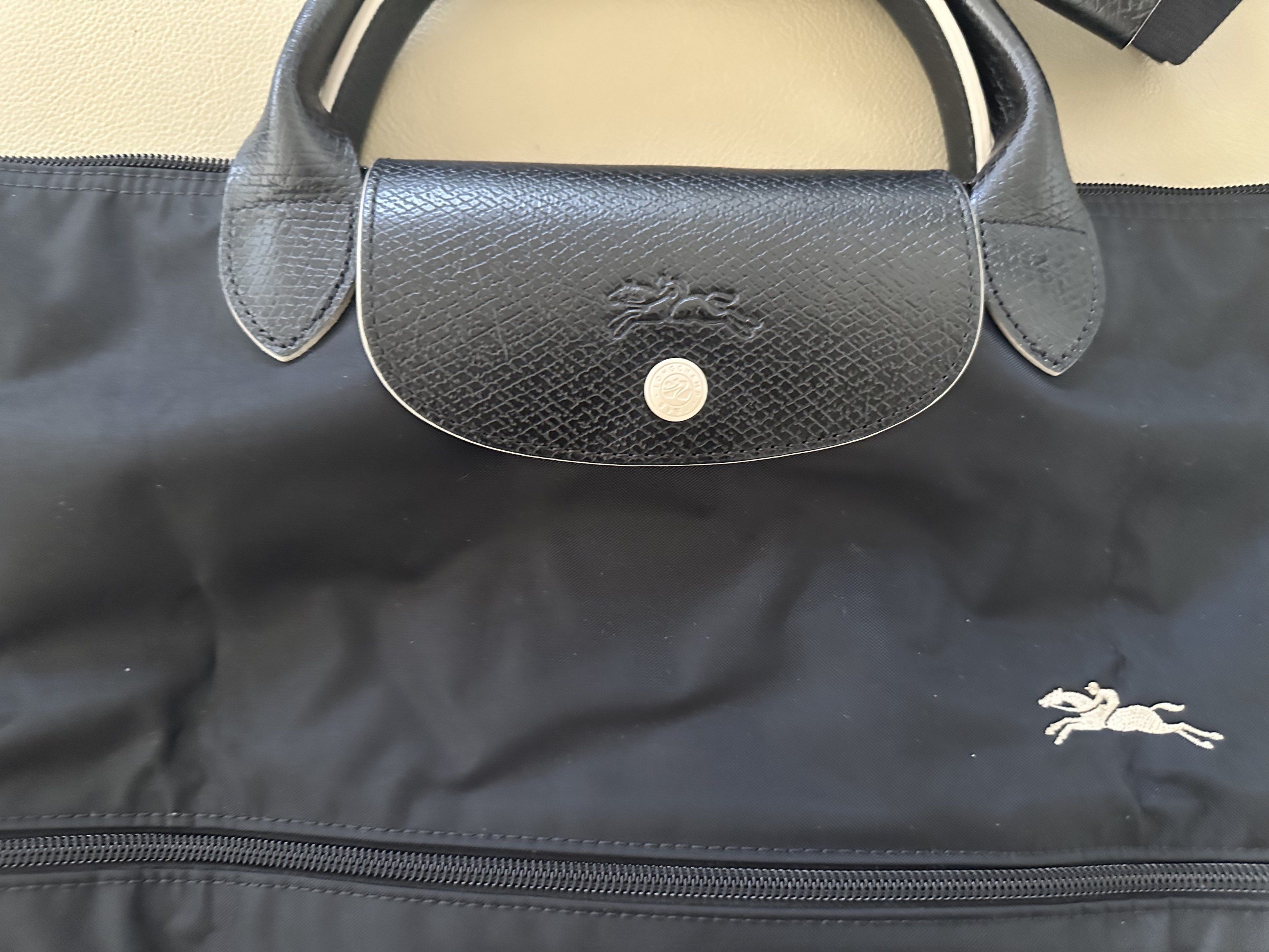 Authentic Longchamp Le Pliage Travel Bag in black (Category: Shoulder Bags) located in Muntinlupa City. Submitted by DeclutterShop (Listing ID 1418836725, Image 3). Description: Authentic Longchamp Le Pliage Travel Bag Expandable Lightly used No gross stains, marks or signs of wear.