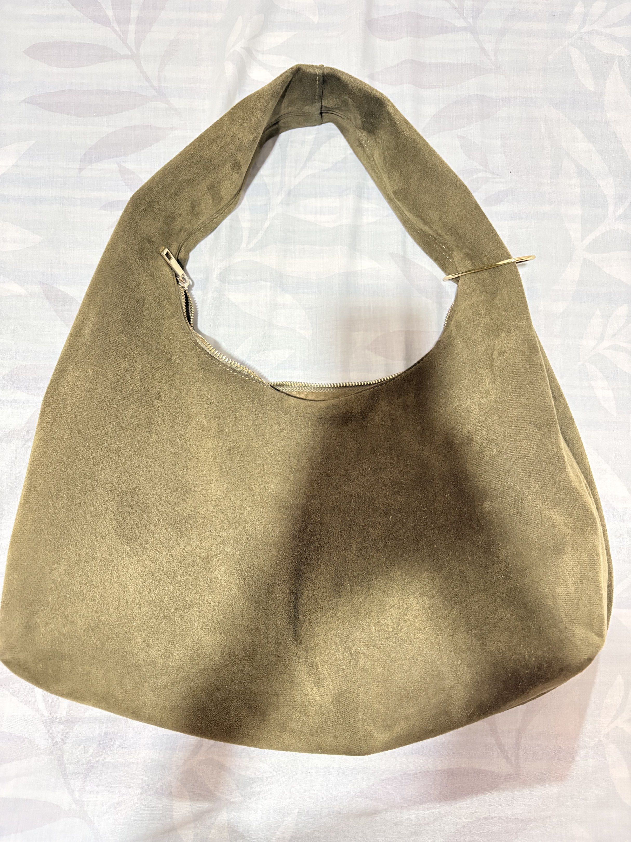 AZTRID Suede Hobo Bag Large (Suede Moss) (Category: Luxury Bags & Wallets) located in Manila. Submitted by tamia444_ (Listing ID 1418814722, Image 3). Description: Inclusions: Gold Charm Holder Dust Bag - Stylish AZTRD hobo bag - Color: Muted olive green - Features a single shoulder strap - Secure zippered closure - Spacious interior with an additional zippered pocket - Made of a soft, suede-like material - Minimalist design with subtle AZTRD log