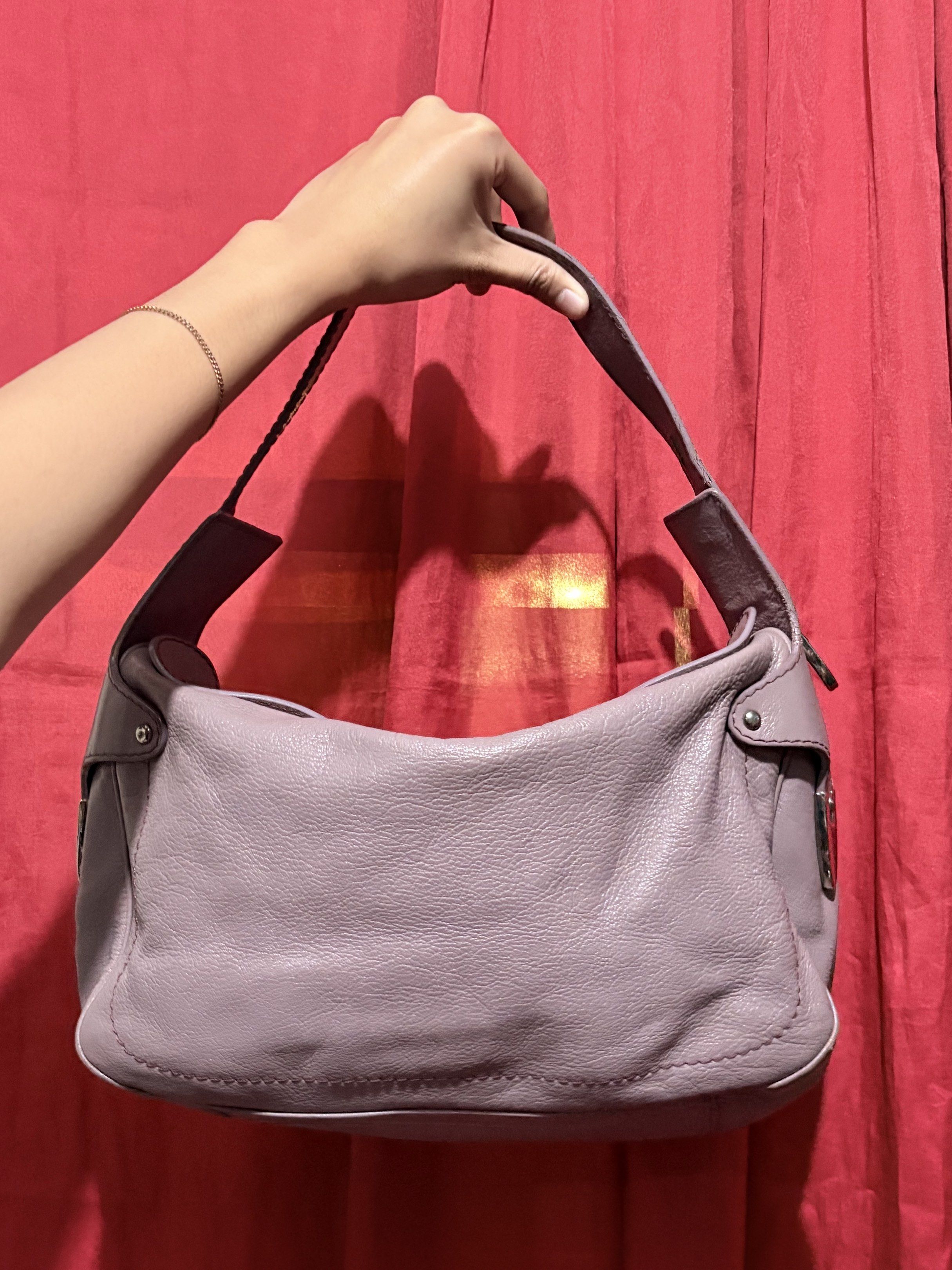 Bally Shoulder Bag (Category: Luxury Bags & Wallets) located in Manila. Submitted by cufflej (Listing ID 1418956936, Image 2). Description: - Lavender Bally shoulder bag - Top zipper closure - Single shoulder strap - Silver-tone logo - Brown fabric lining - Silver-tone Bally metal tag - Curved shape - Leather exterior.