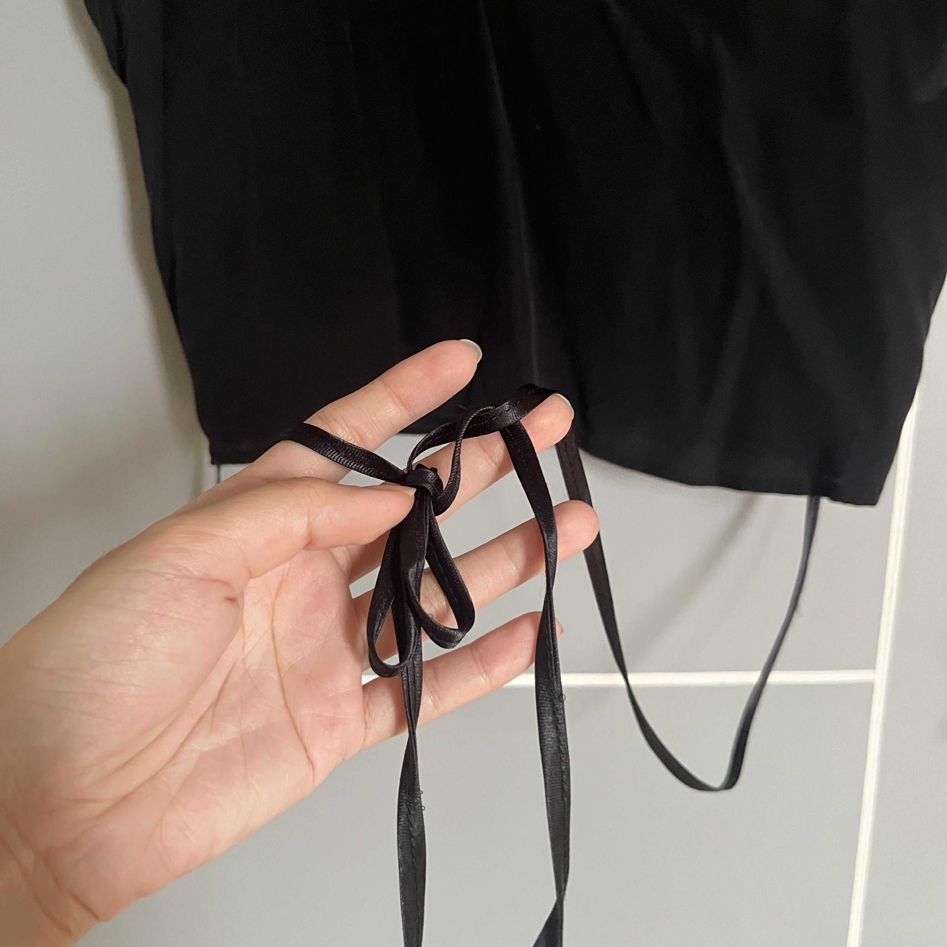Black Deep Neckline Top (Category: Sleeveless) located in Taguig. Submitted by _handydandy (Listing ID 1418927651, Image 2). Description: - SABA black crop top - Built with satin string to wrap around your waist - Deep V-neck design - lightweight fabric; presko - Short sleeves - Tie details on the sides - Size 8 - Made of a smooth material.