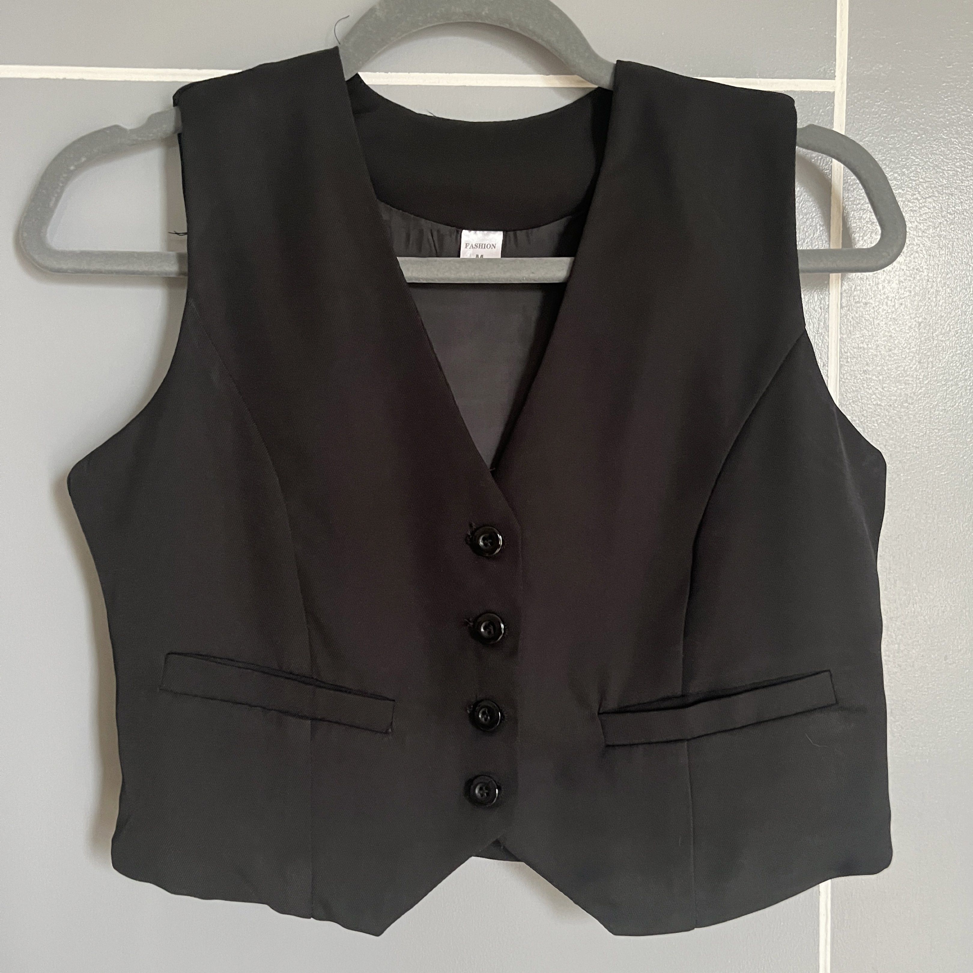 Black Vest (Medium) (Category: Vests) located in Taguig. Submitted by _handydandy (Listing ID 1418926968, Image 1). Description: - Black vest - Used once; no flaws - Size: Medium - V-neck design - Four-button closure - Two front pockets - Great for layering.