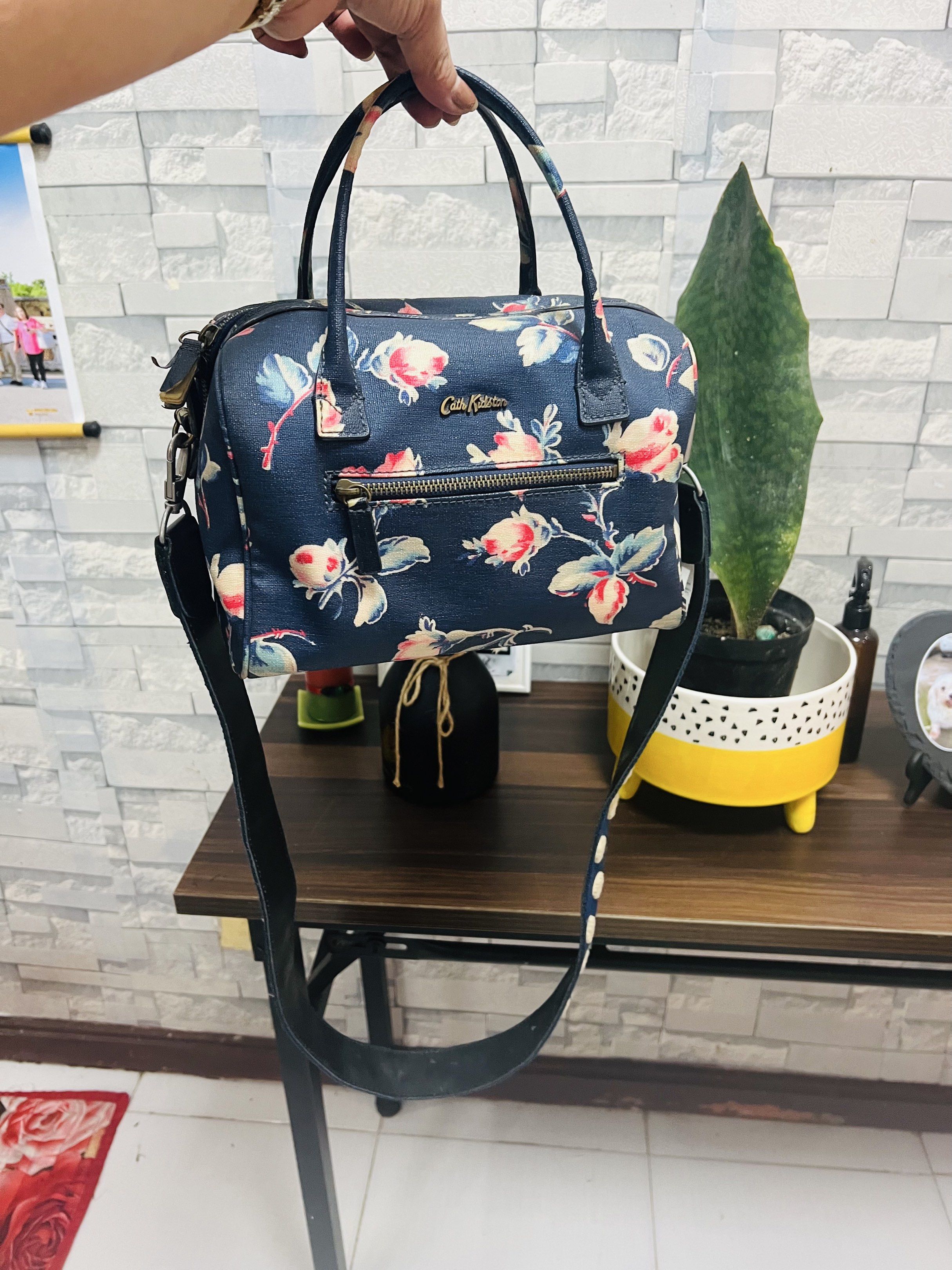 Cath Kidston Floral Handbag with Polka Dot Strap (Category: Tote Bags) located in Antipolo. Submitted by murapod2 (Listing ID 1418976757, Image 2). Description: - Cath Kidston handbag - Floral pattern on navy blue background - Top handle and detachable polka dot strap - Front zipper pocket - Main compartment with zipper closure - Interior with Cath Kidston label.
