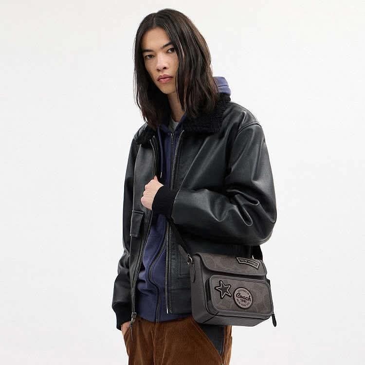 Coach Charter Crossbody Bag (Category: Luxury Bags & Wallets) located in Quezon City. Submitted by k2collection.mnl (Listing ID 1418951984, Image 2). Description: - Coach Charter crossbody bag - Color: Grey - Features: - Flap closure - "New York" patch - Star patch - Coach logo - Adjustable long strap - Interior: Black - Material: Grey leather and Coach signature pattern.
