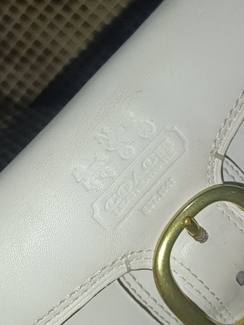 Coach Bleecher Trifold Buckle Snap Long Wallet (Category: Luxury Bags & Wallets) located in San Pedro. Submitted by elevens_online_thrift_shop (Listing ID 1418927697, Image 2). Description: A vintage Coach Bleecker tri-fold buckle snap wallet in white leather with gold-tone hardware. Style is from an older collection, possibly the "Soho" line. Which is very on-demand in todays market. Market Price: php 4,000.00 to 5,800.00 Product Information Bra