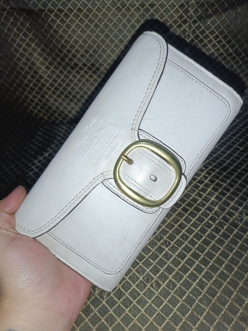 Coach Bleecher Trifold Buckle Snap Long Wallet (Category: Luxury Bags & Wallets) located in San Pedro. Submitted by elevens_online_thrift_shop (Listing ID 1418927697, Image 1). Description: A vintage Coach Bleecker tri-fold buckle snap wallet in white leather with gold-tone hardware. Style is from an older collection, possibly the "Soho" line. Which is very on-demand in todays market. Market Price: php 4,000.00 to 5,800.00 Product Information Bra