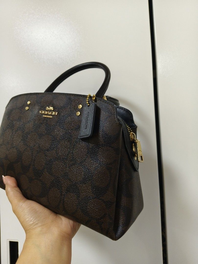 Coach mini lillie (Category: Luxury Bags & Wallets) located in Rizal. Submitted by ortegaalex06291 (Listing ID 1418908841, Image 3). Description: - Coach satchel handbag - Brown signature print - Top handle and detachable shoulder strap - Zip closure - Gold-tone hardware - Includes Coach hangtag - Black interior - Structured shape - Classic design.