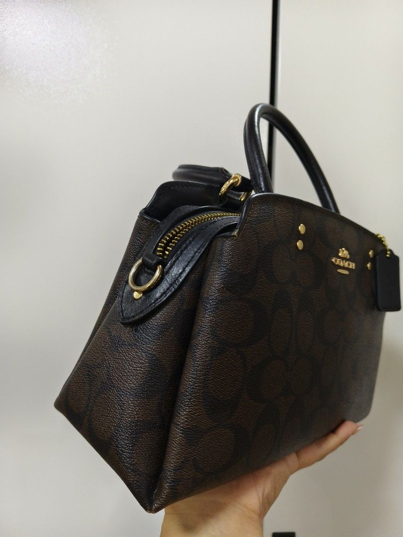 Coach mini lillie (Category: Luxury Bags & Wallets) located in Rizal. Submitted by ortegaalex06291 (Listing ID 1418908841, Image 2). Description: - Coach satchel handbag - Brown signature print - Top handle and detachable shoulder strap - Zip closure - Gold-tone hardware - Includes Coach hangtag - Black interior - Structured shape - Classic design.
