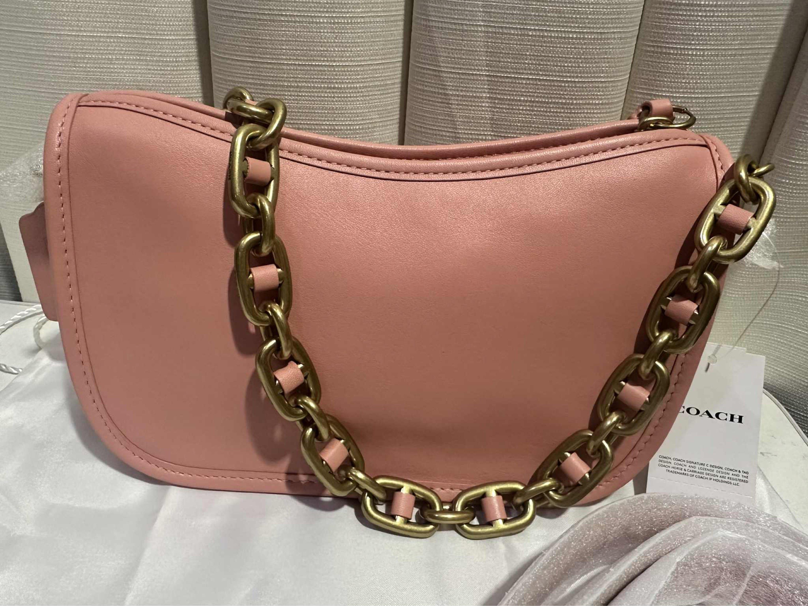 Coach Swinger in Candy Pink (Category: Luxury Bags & Wallets) located in Quezon City. Submitted by selinabu (Listing ID 1418968685, Image 2). Description: - Coach swinger shoulder bag - Beautiful pink color - Includes chain strap and additional strap - Comes with dust bag - Features Coach leather tag - Gold-tone chain strap - Curved shape Color: Candy Pink Size: 9.25”L x 5.5”H x 2.75”W MSRP: $425 Carried once only, technically still brand new. No