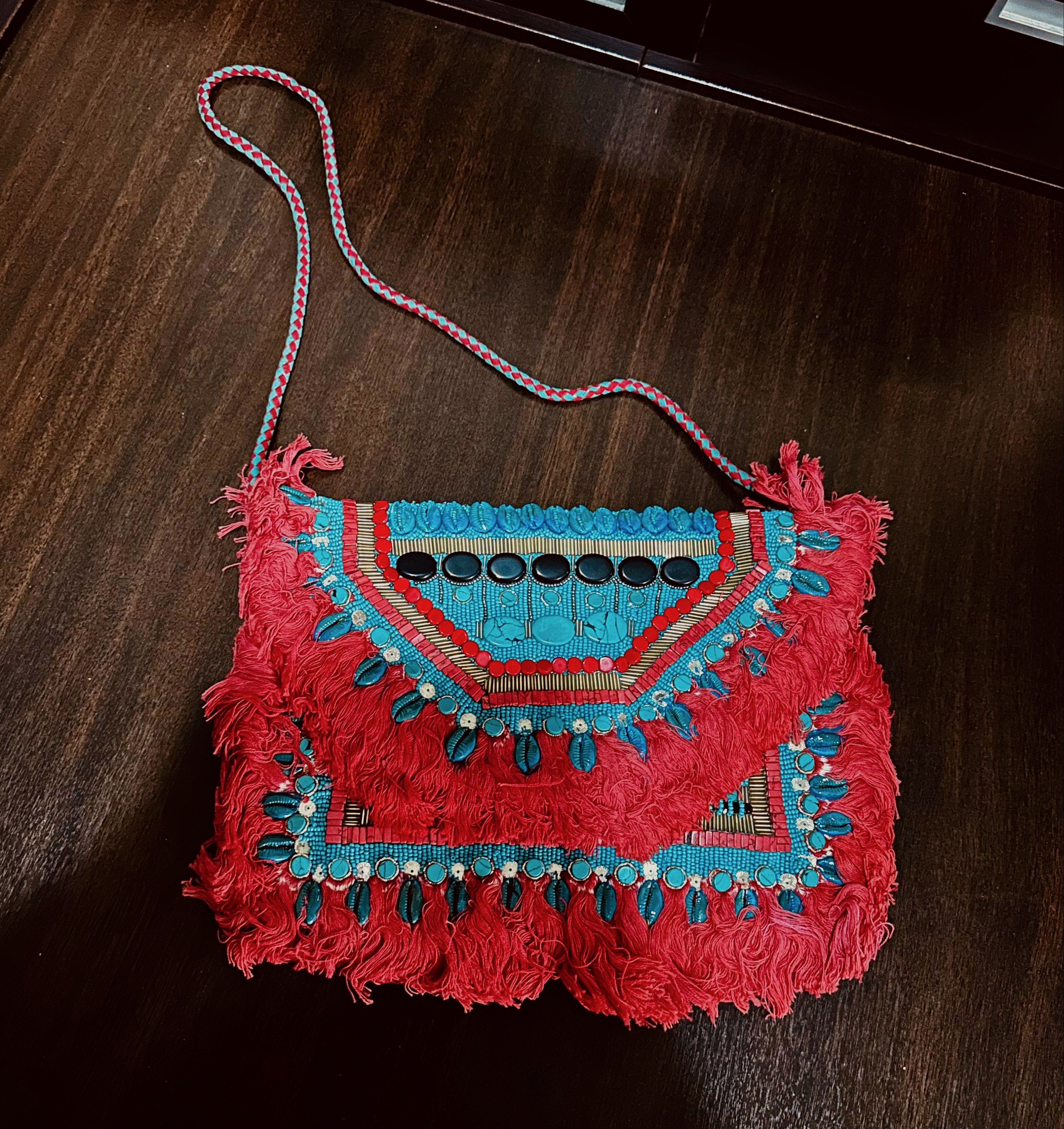 Ethnique Embroidered Clutch Bag (Category: Luxury Bags & Wallets) located in Quezon City. Submitted by spatio (Listing ID 1418069728, Image 2). Description: - Ethnique clutch or sling bag - Intricate embroidery and fringe - Vibrant red and turquoise colors - Turquoise suede interior - Zippered pocket - Braided strap - Adds a pop of color to any outfit.