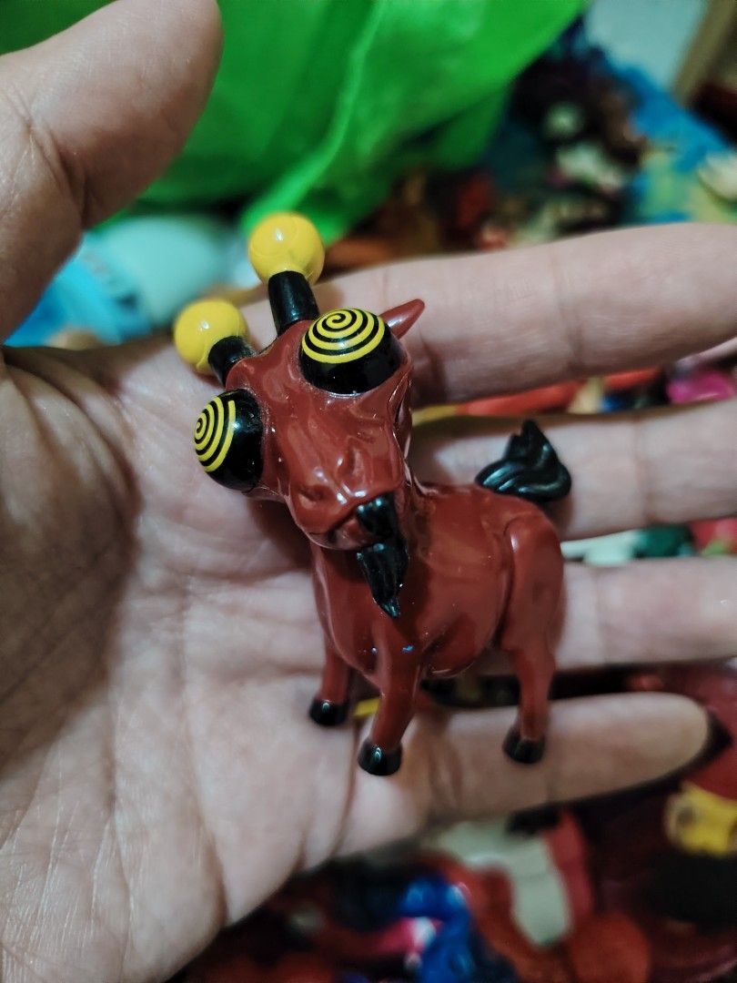 Fe ge teev goat figure (Category: Figurines & Statues) located in Iligan City. Submitted by shehabdor98515 (Listing ID 1418812586, Image 1). Description: - Red body with black accents - Features two yellow orbs on top of the head - Spiral patterned eyes - Standing position - Includes a black tail - Collectible item.