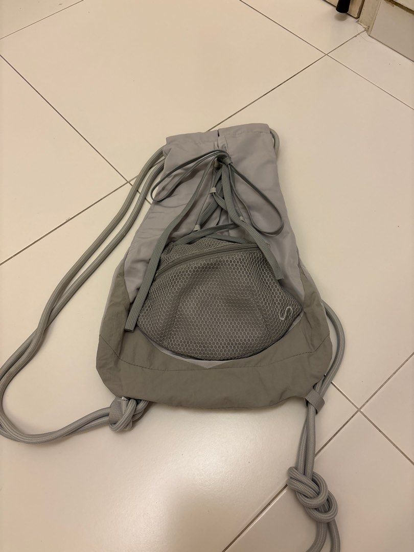 Grey Drawstring Backpack (Category: Backpacks) located in Singapore. Submitted by crystalcar (Listing ID 1418956243, Image 1). Description: - Grey drawstring backpack - Front mesh pocket - Secure drawstring closure - Perfect for gym, travel, and everyday use.
