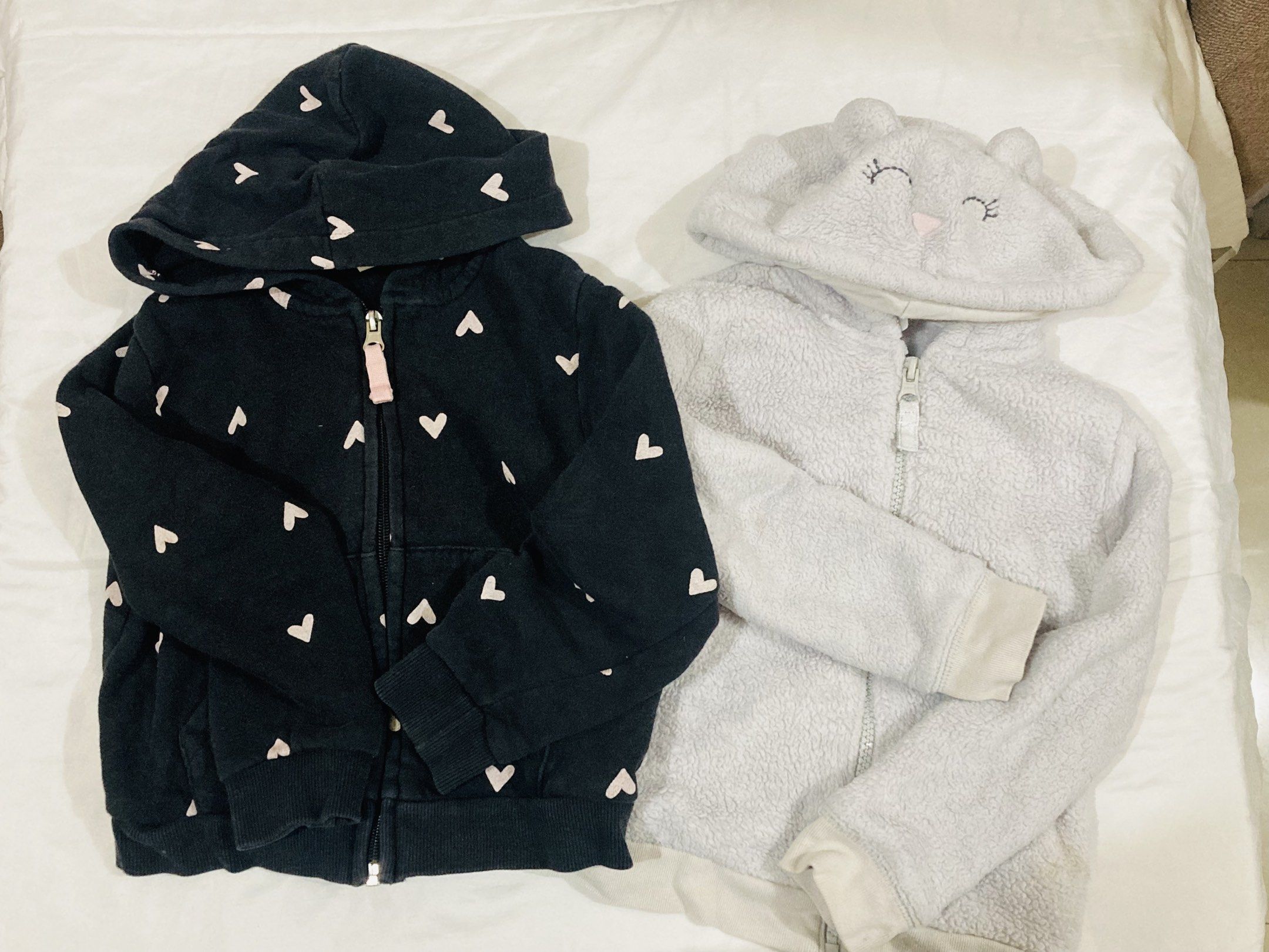 H&M and Carter's Toddler Hoodies bundle (Category: Babies & Kids Fashion) located in La Trinidad. Submitted by secondsmatter (Listing ID 1418901432, Image 1). Description: - Two toddler hoodies for sale! - Includes: - Black H&M hoodie with heart patterns and zipper closure. - Gray Carter's bear-themed hoodie from Carter's (size 3T). - Both hoodies feature: - Hoods - Long sleeves - Perfect for keeping your little one warm and stylish!.